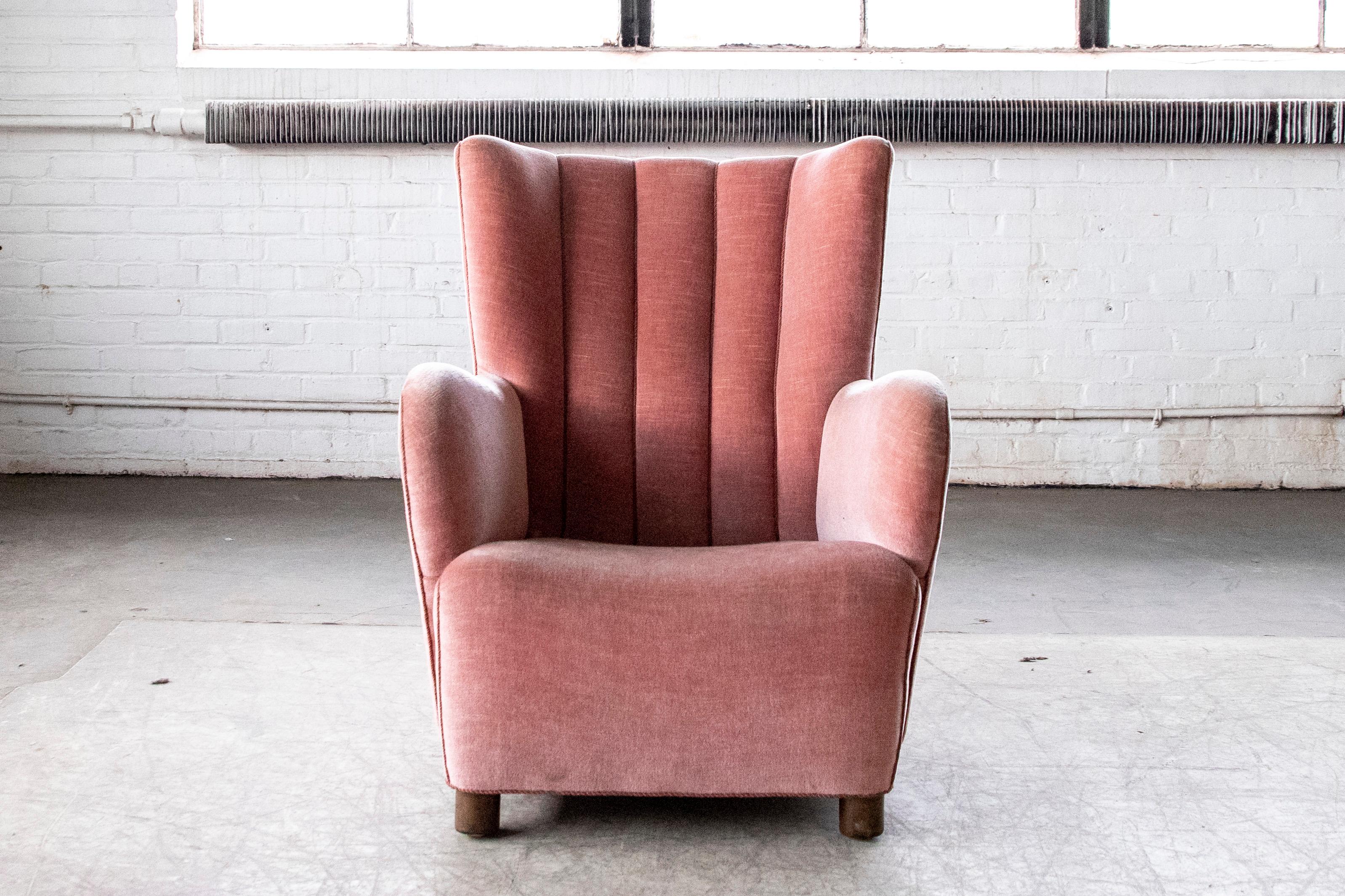 Sublime highback lounge chair with channeled back made in Denmark in the 1940s. The proportions are very similar to Fritz Hansen's model 1518 but with a slimmer and higher Silhouette. Superbly stylish and comfortable the chair has a very strong