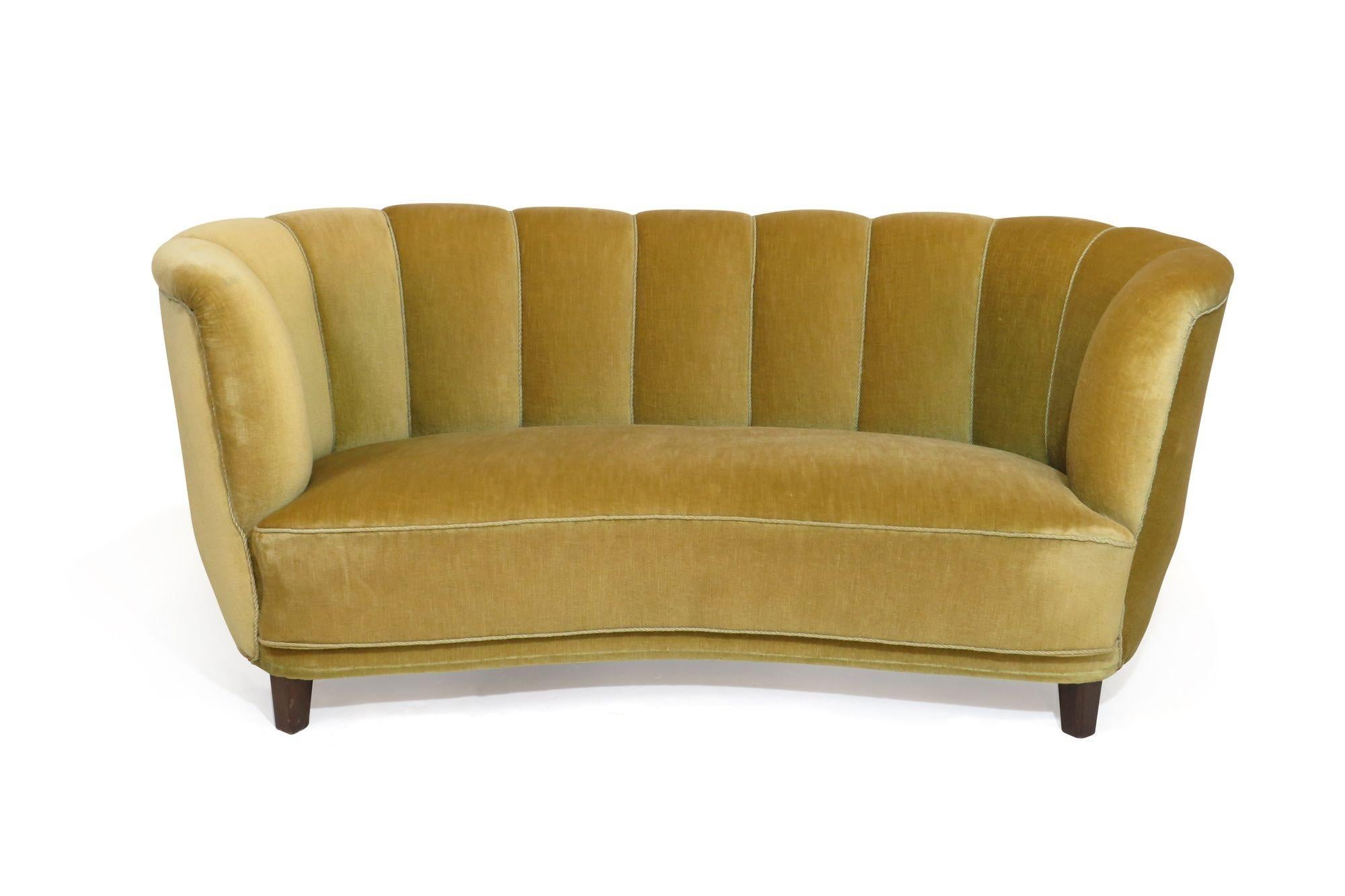 Danish channel back curved settee crafted of a solid wood frame with eight-way hand-tied springs, horsehair and cotton padding, covered in the original yellow gold mohair. Good vintage condition can be used as found, or fully reupholstered.
 
Seat