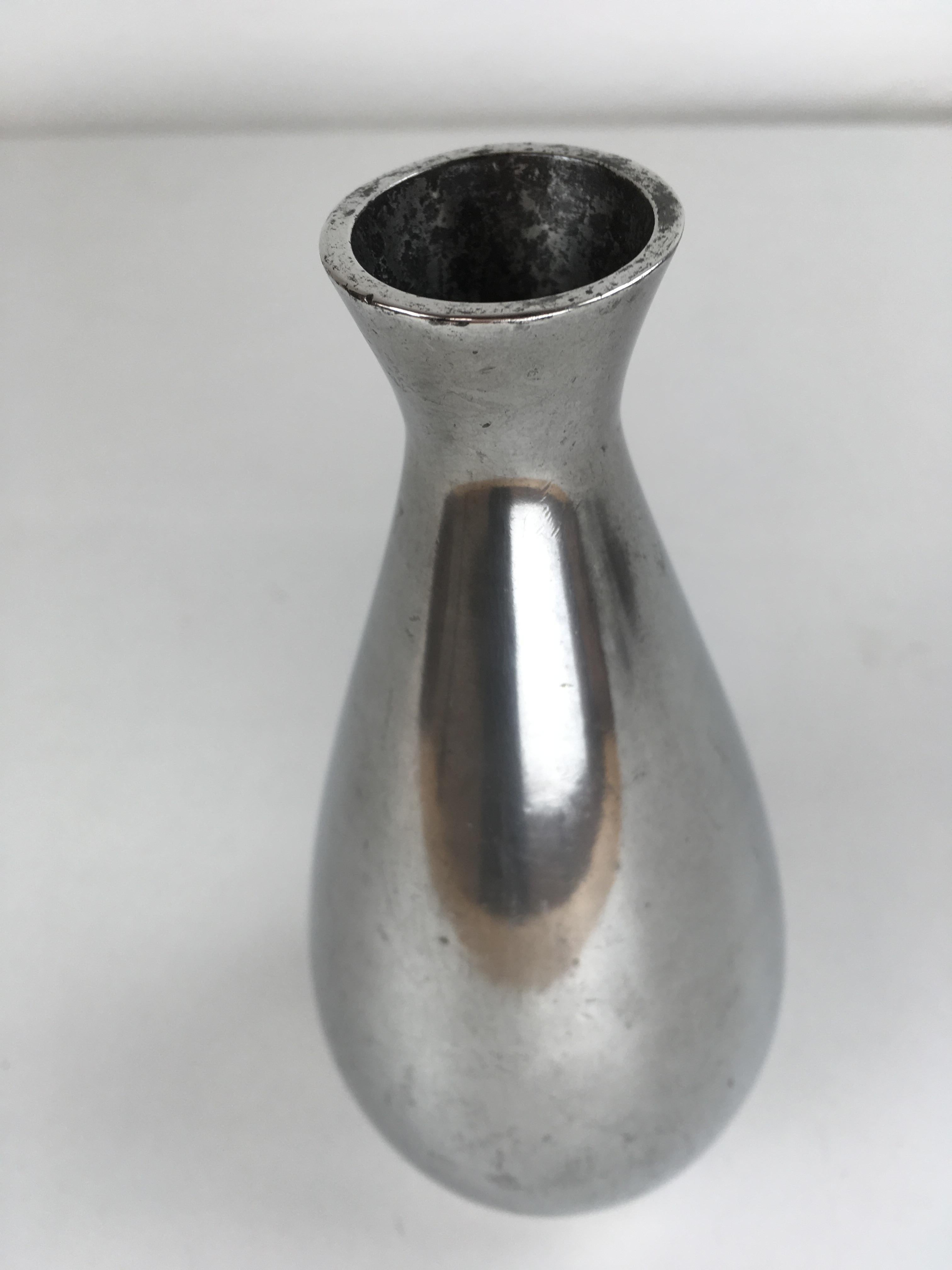 Danish Just Andersen pewter vase produced by Just Andersen A/S in the 1940 - 1950's.

The vase is marked with Just. Andersens triangle mark. 

Just Andersen 1884-1943 was born in Godhavn on the Disko island, which is located on the west side of
