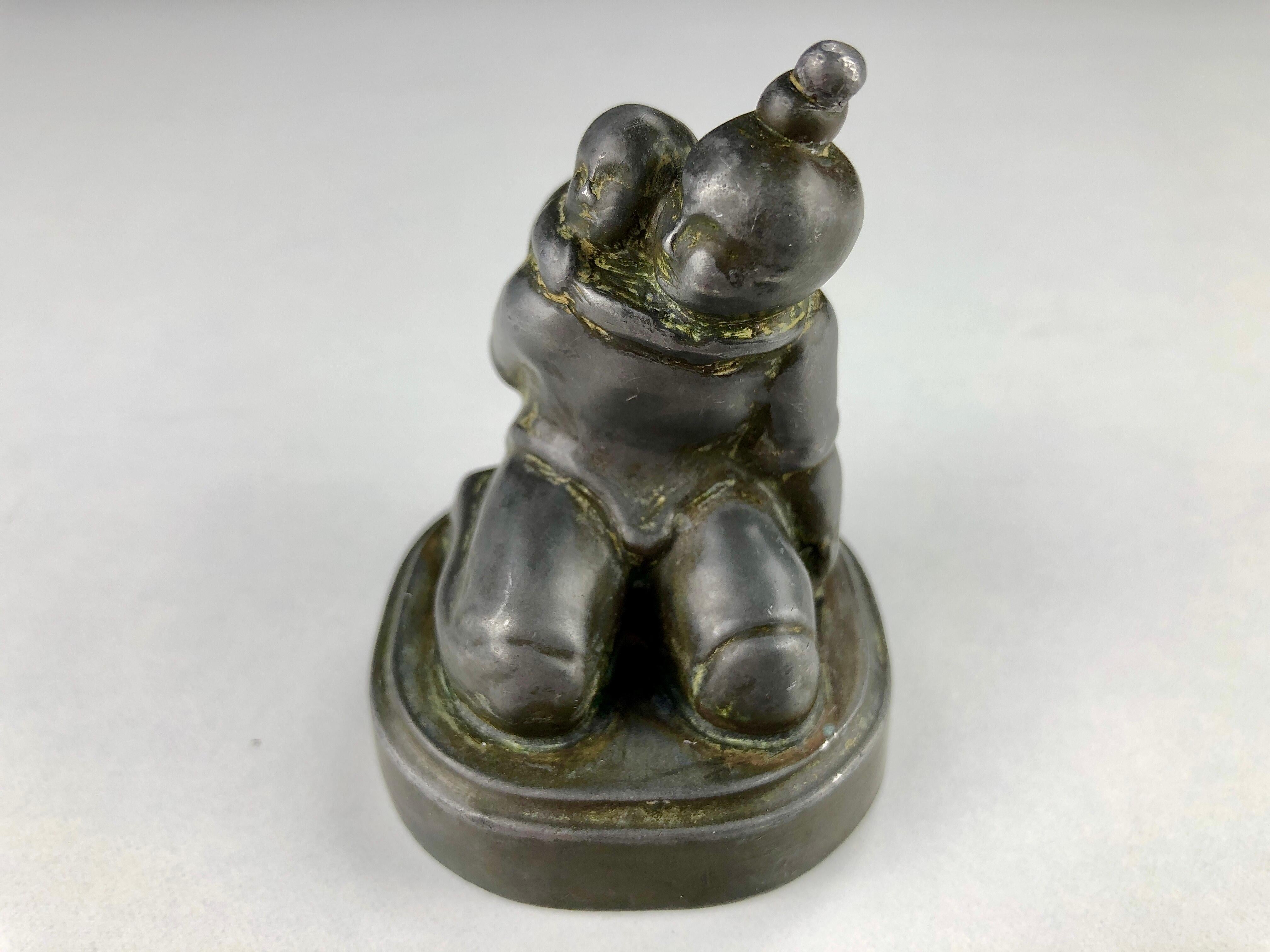 1940s Danish Just Andersen Disco Metal Figurine of Inuit Mother and Child

The figurine is made in Disco metal, an alloy of lead and antimony, which was Just Andersen's own invention and named after the Disko Bay in Greenland, where he grew up.

The