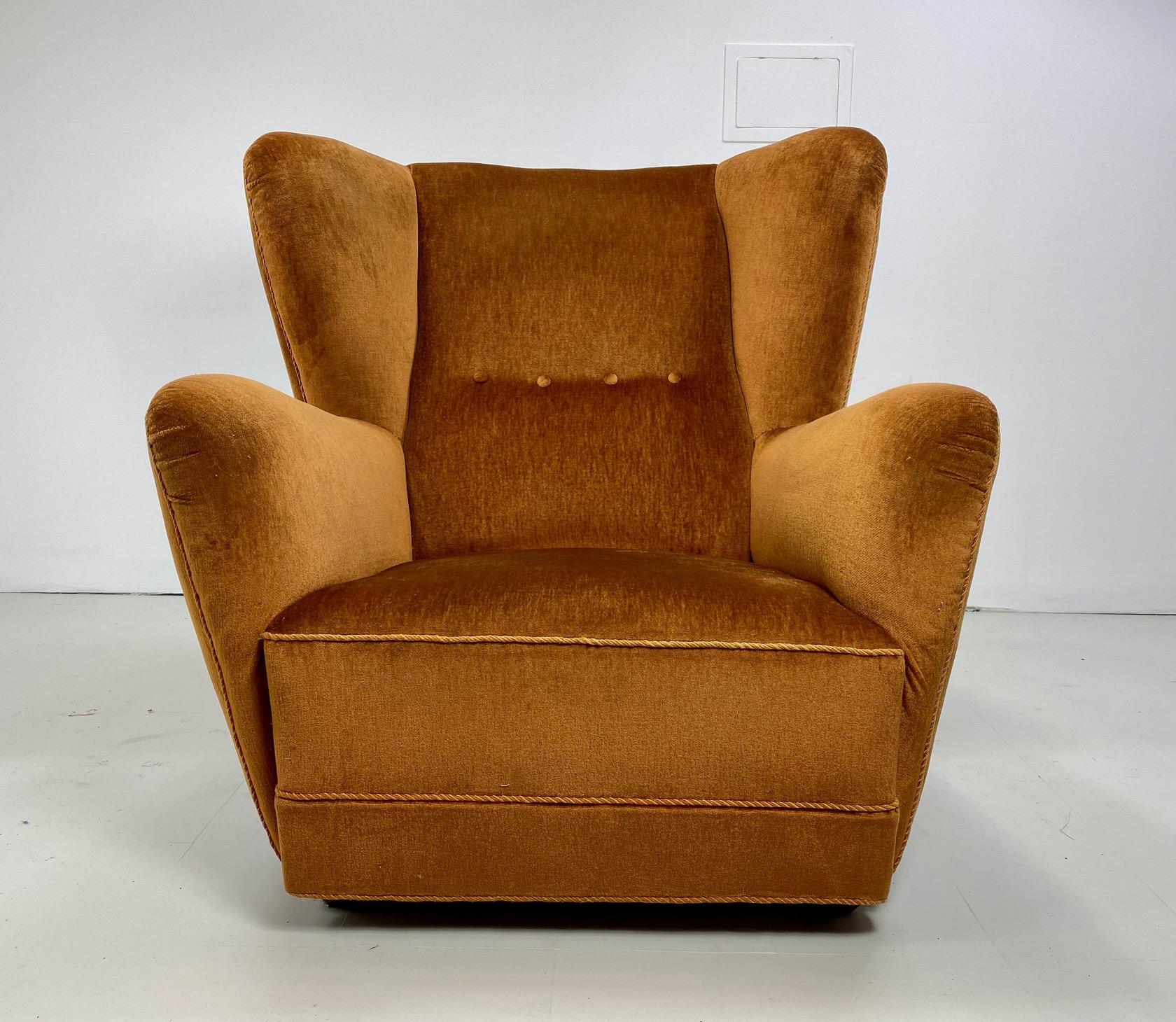 1940's Danish lounge chair. Large scale chair. High quality velvet upholstery. Wood ball feet on front of the chair.