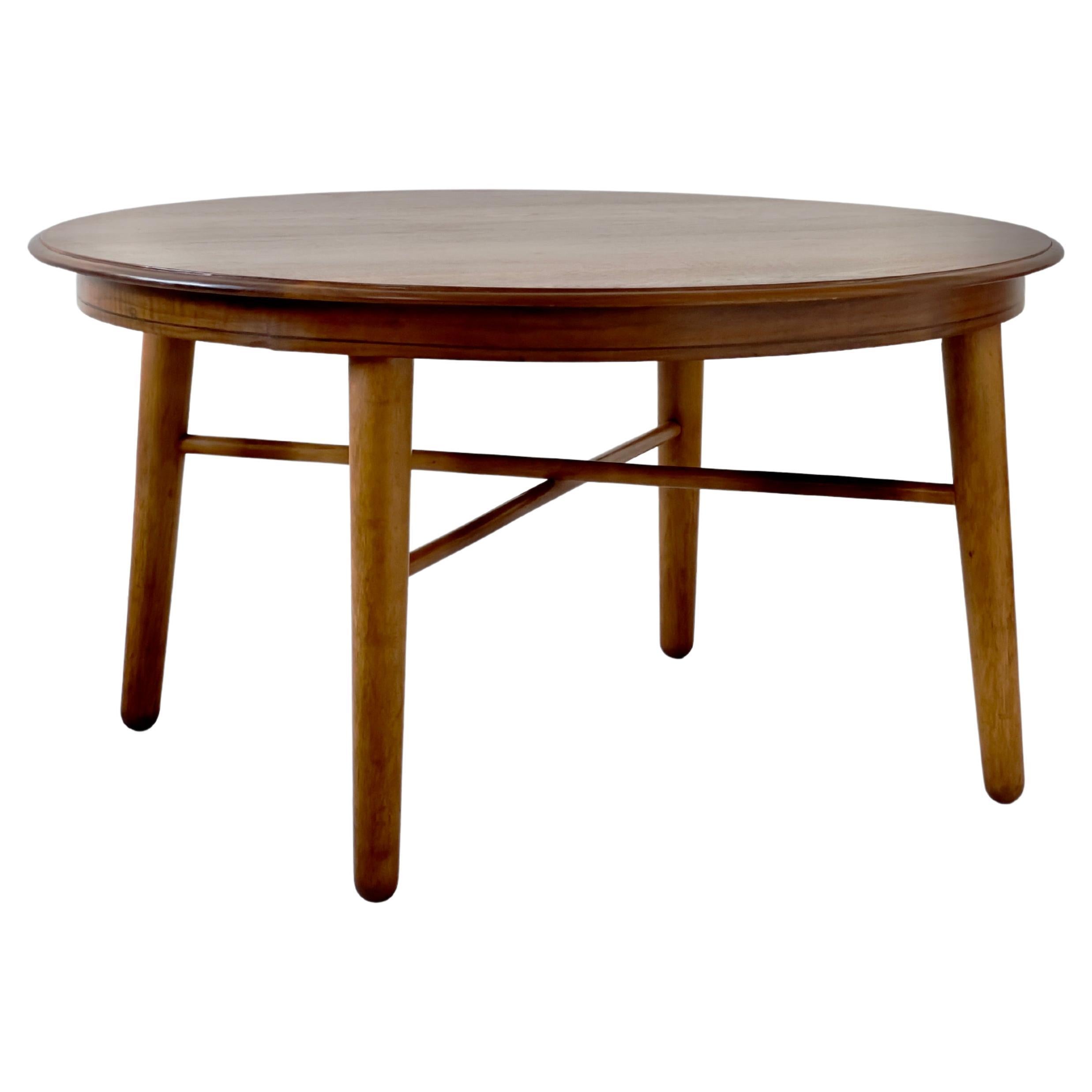 This super elegant 1940s Danish Modern coffee table is a true masterpiece of mid-century design. Crafted with meticulous attention to detail and timeless aesthetics.
The tabletop is constructed from solid nut wood, which not only adds to its
