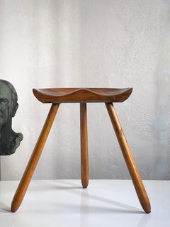 1940s Danish modern stool of beech wood with hand carved seat and tapering legs.