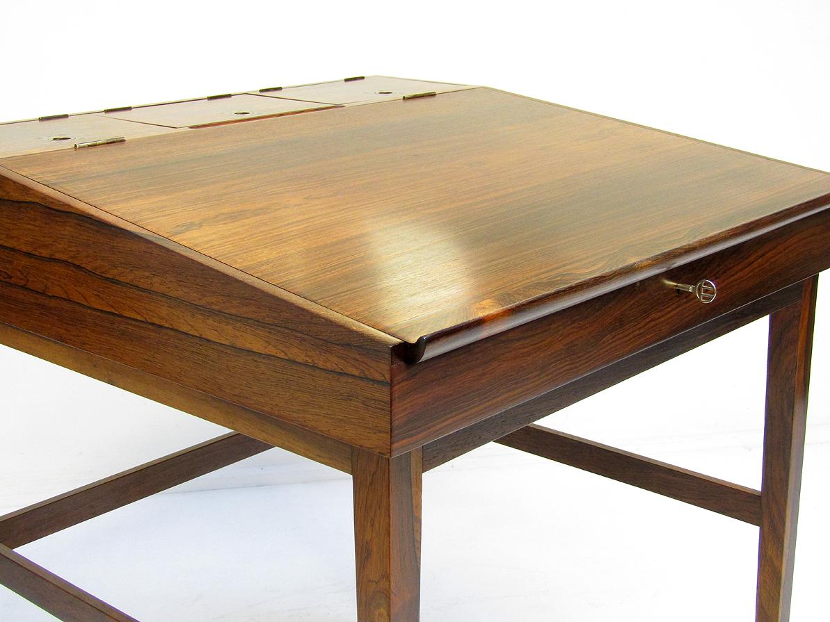 A beautifully proportioned NV-40 writing desk by Finn Juhl for Neils Vodder.

In Rio rosewood with brass detail this rare 1940s desk is in excellent condition.

It retains its original key, the lock in perfect working condition.

The writing