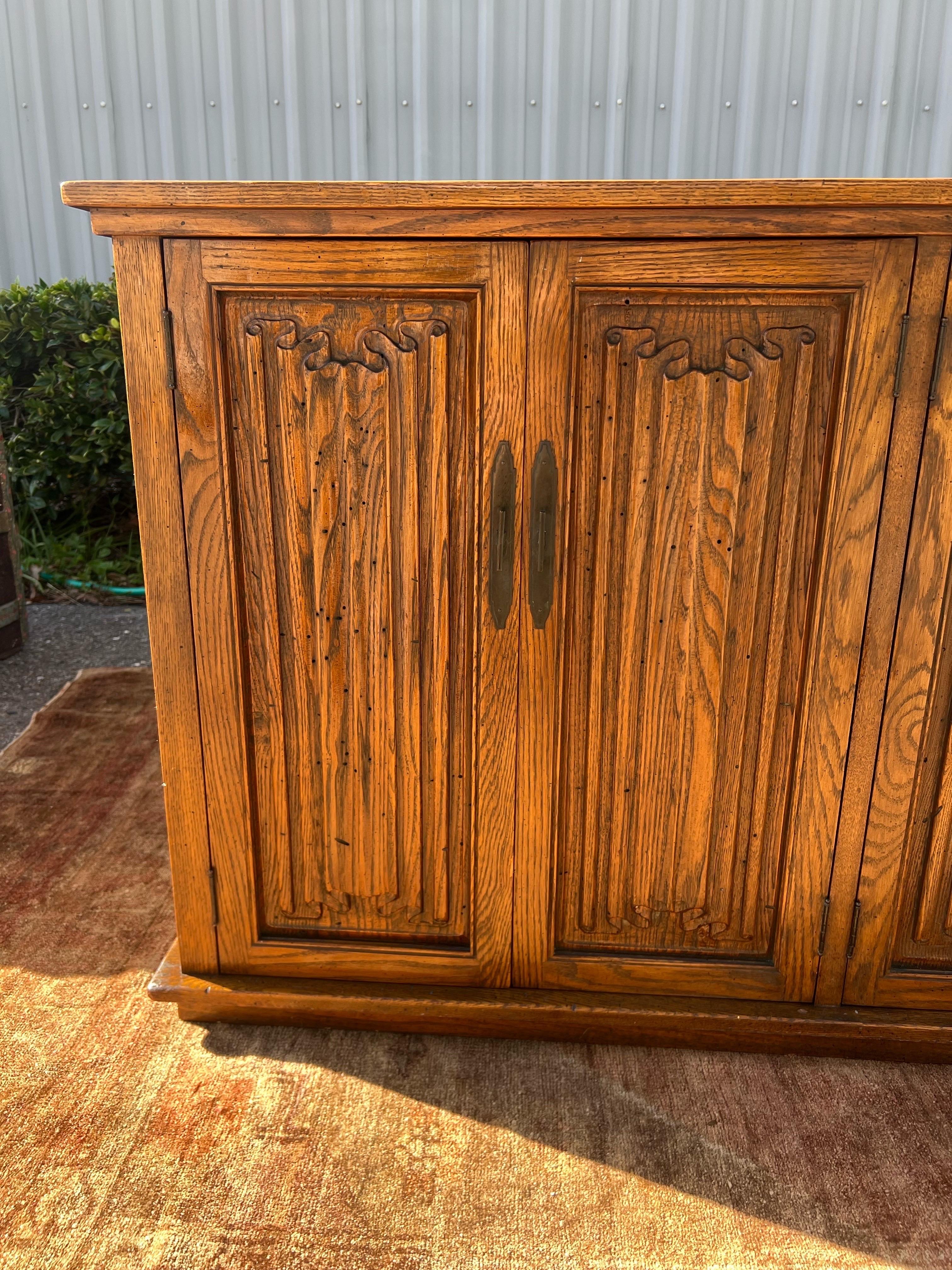 A large Danish modern oak sideboard attributed to Henning Kjaernulf for EG Kvalitetsmobel. 6 hinged doors with sculptural brutalist 