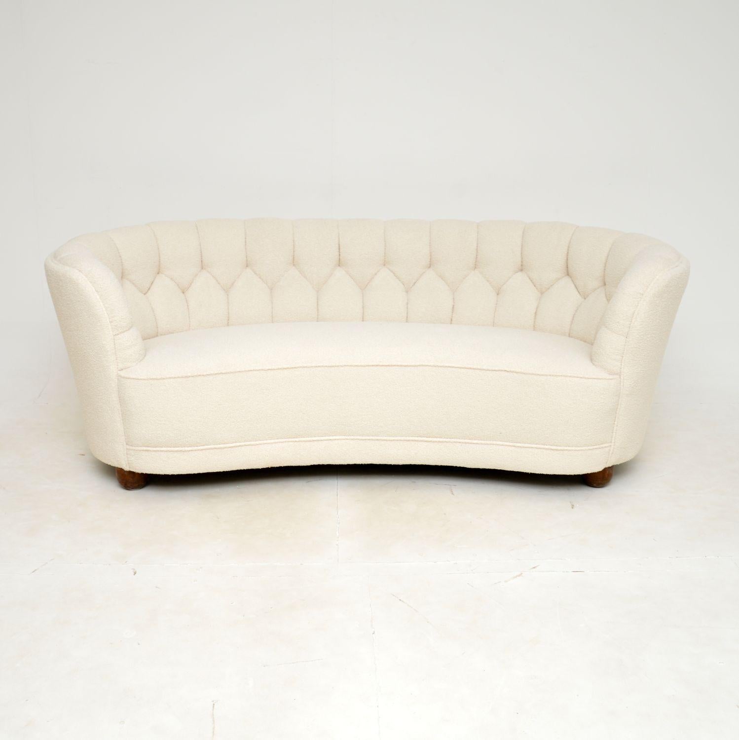 An outstanding vintage Danish curved cocktail sofa, dating from the 1940s.

This is of exceptional quality with an absolutely beautiful design. The curved frame is extremely sturdy and very heavy. It is well sprung and comfortable, it sits on solid