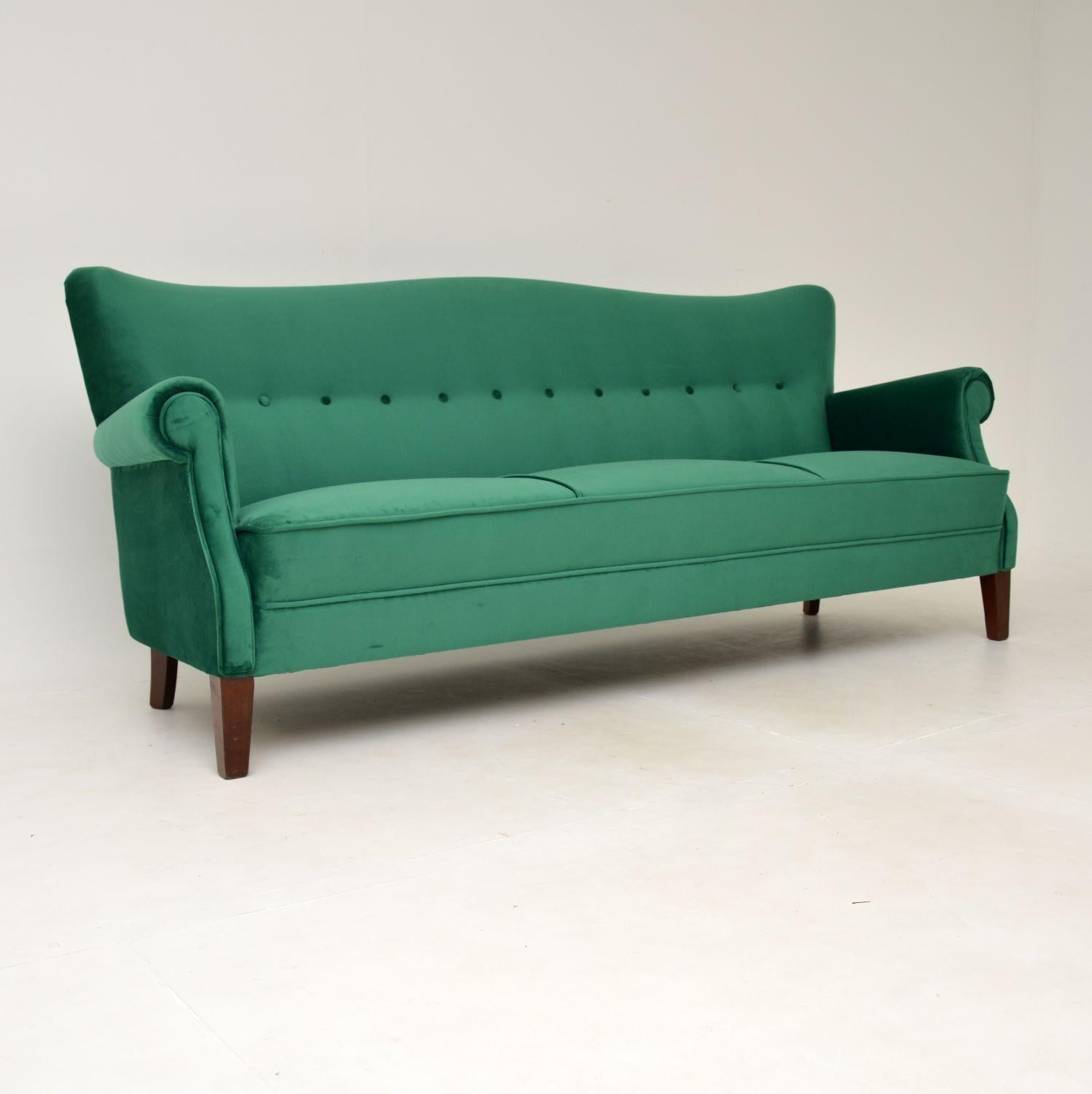 A stunning and very comfortable vintage Danish sofa. This was made in Denmark, it dates from around the 1940-1950’s.

The quality is amazing, this is extremely well built and sturdy. It is well sprung, well padded and very supportive. The design