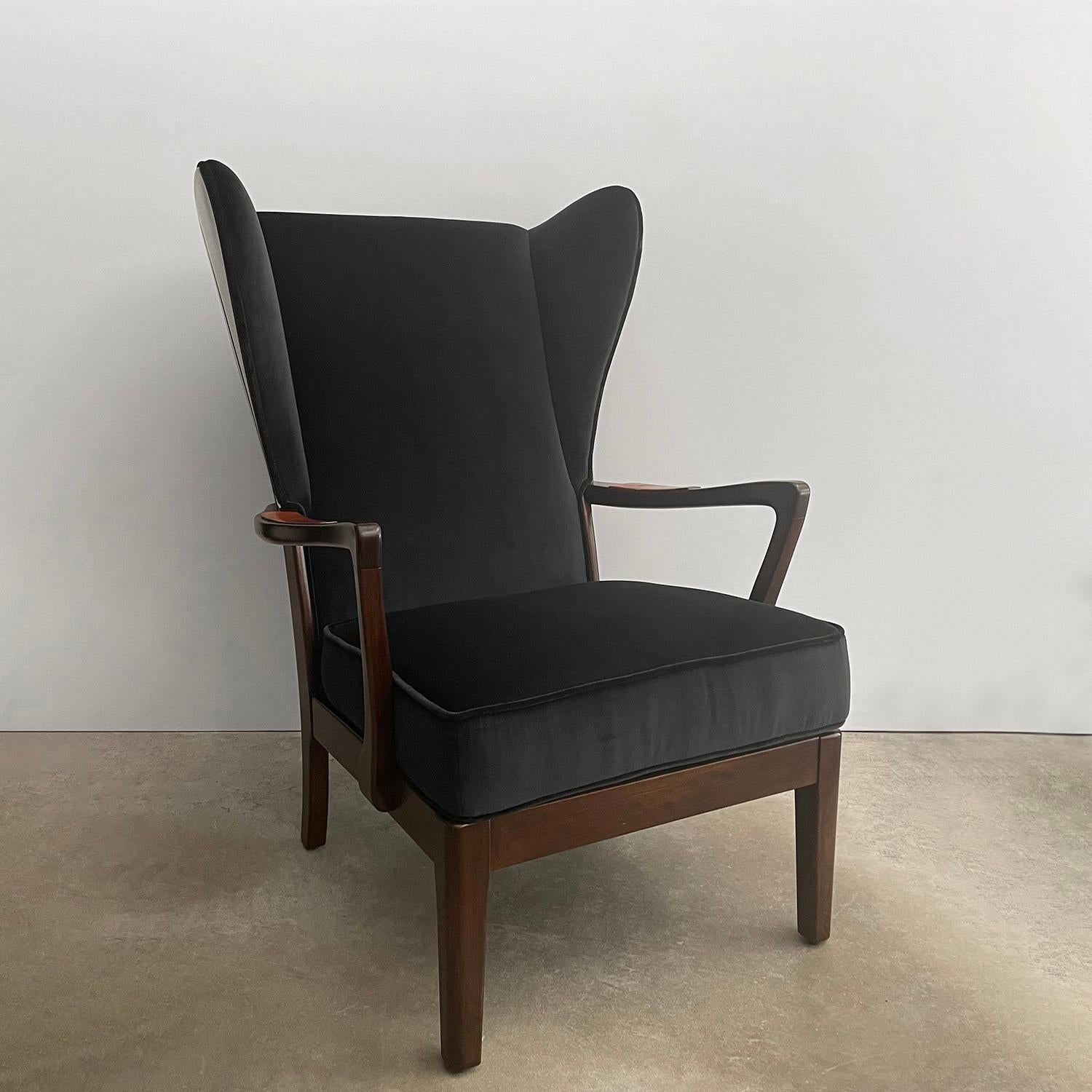 1940's Danish wingback lounge chair 
This handsome lounge chair has a distinguished and structured silhouette 
Newly refinished wood paneled frame accented with original leather hand rests 
Newly reupholstered in silky Italian velvet 
Patina from