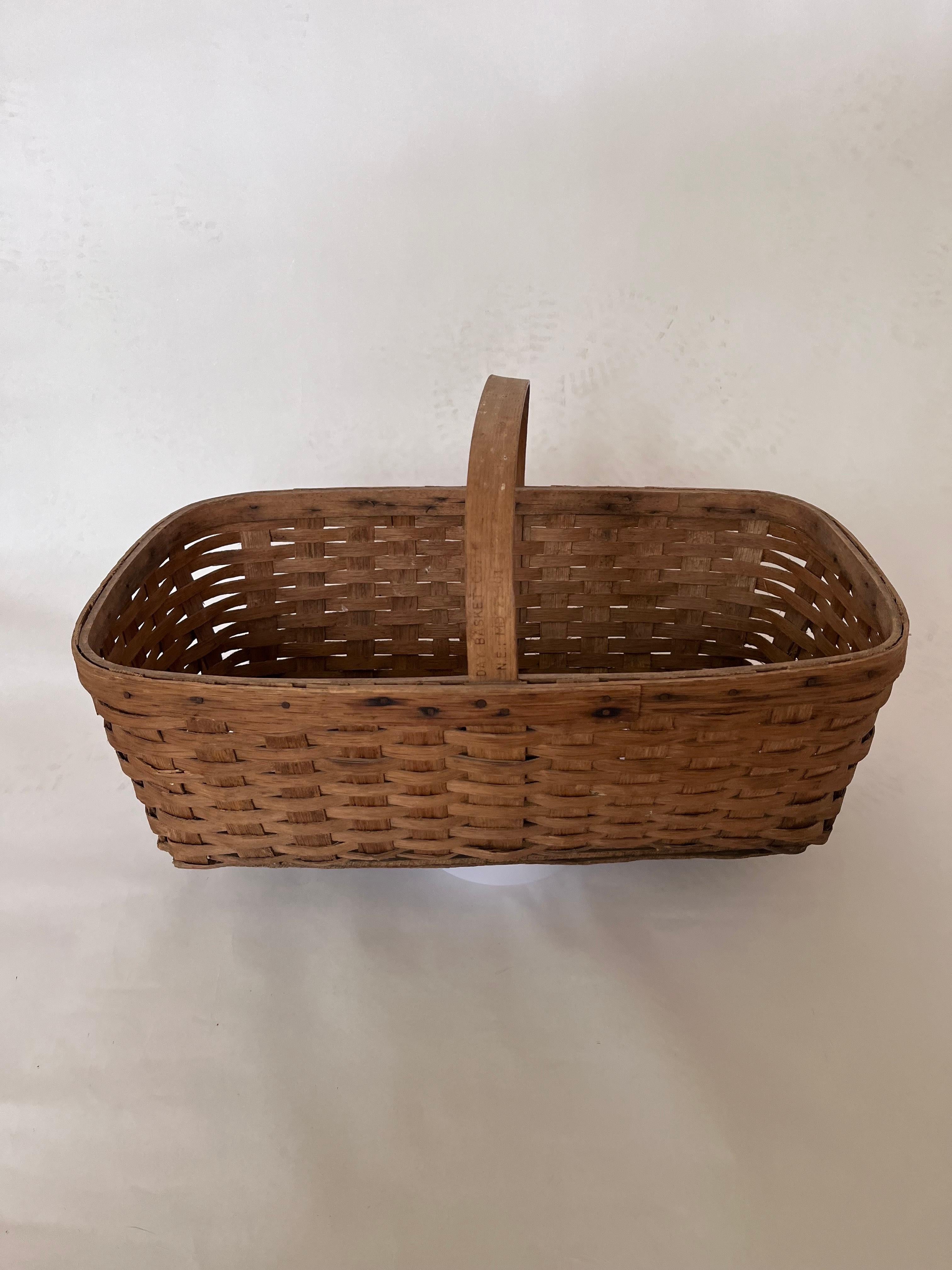 1940s Day Basket Co. Handwoven White Oak Long Market Basket with Stamped Handle

This charming 1940s handwoven market basket by the Day Basket Company of Maryland is a beautiful and functional example of American craftsmanship. Expertly woven from
