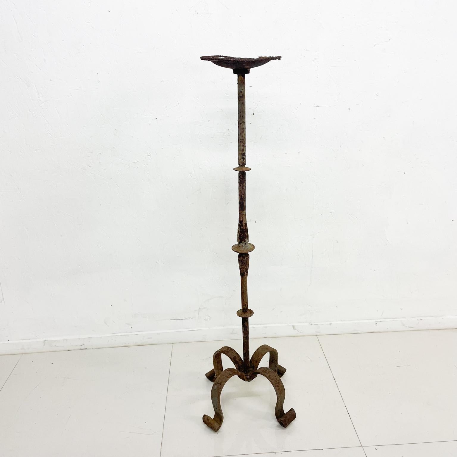 Decorative iron stand
1940s decorative distress rustic hand forged iron sculptural floor stand candle holder 
Original vintage unrestored preowned distressed condition. Rusty condition.
Refer to all images provided.
43.5 tall x 12 x 12
Local LA
