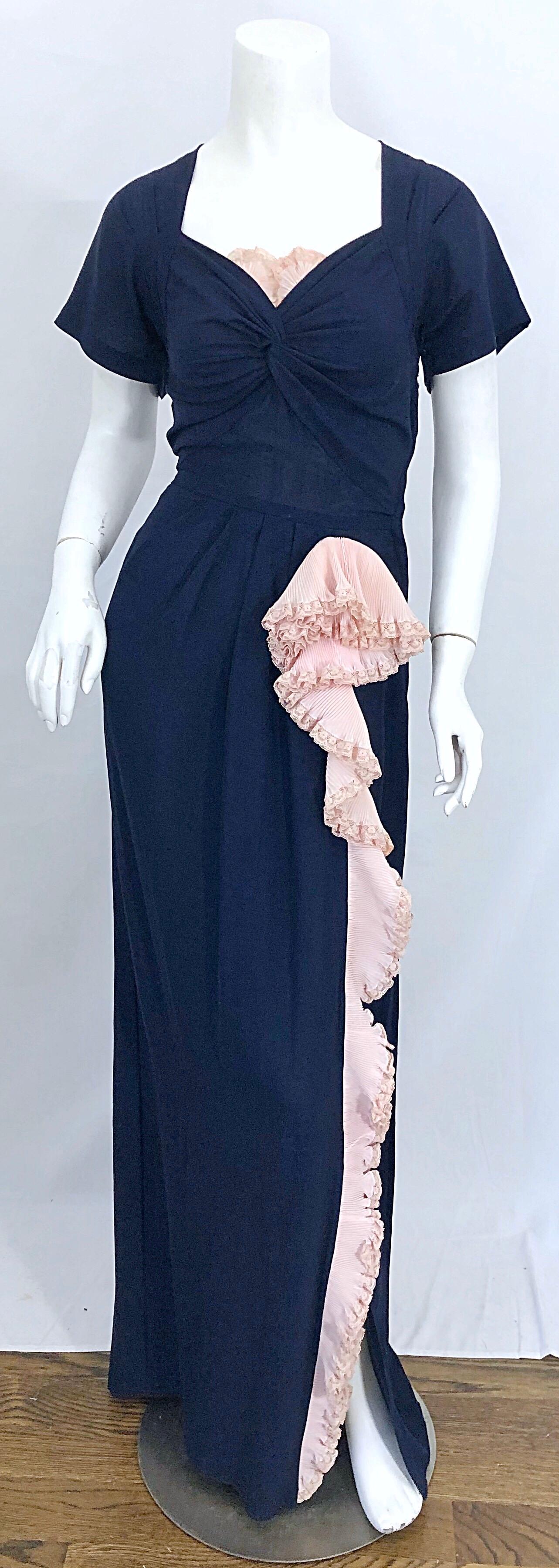 Beautiful vintage 1940s demi couture navy blue and light pink short sleeve crepe gown! Features a gathered sweetheart neckline with pale pink lace above the bust. Pale pink ruffle along the left leg, with a slight slit at the hem. The back of the