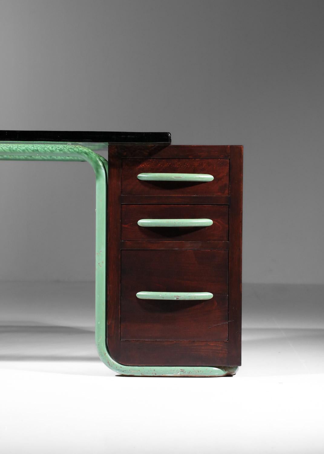 Französischer Schreibtisch aus den 1940er Jahren. Grün lackiertes Stahlrohrgestell (Originallackierung), Schubladenschrank aus Massivholz und Furnier, dicke Glasplatte aus derselben Zeit. Sehr guter Vintage-Zustand, man beachte die Alters- und