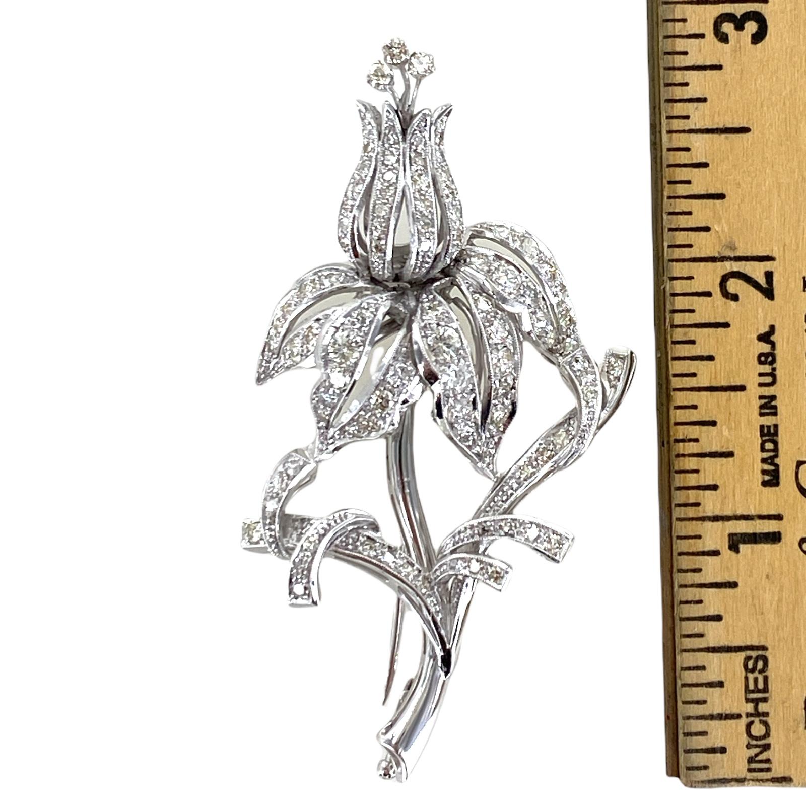 Handcrafted around 1940's, this diamond tulip pin is fashioned in 14 karat white gold. The brooch features round brilliant and single cut diamonds weighing approximately 3.00 carat total weight and graded I-J color and SI clarity. The pin measures