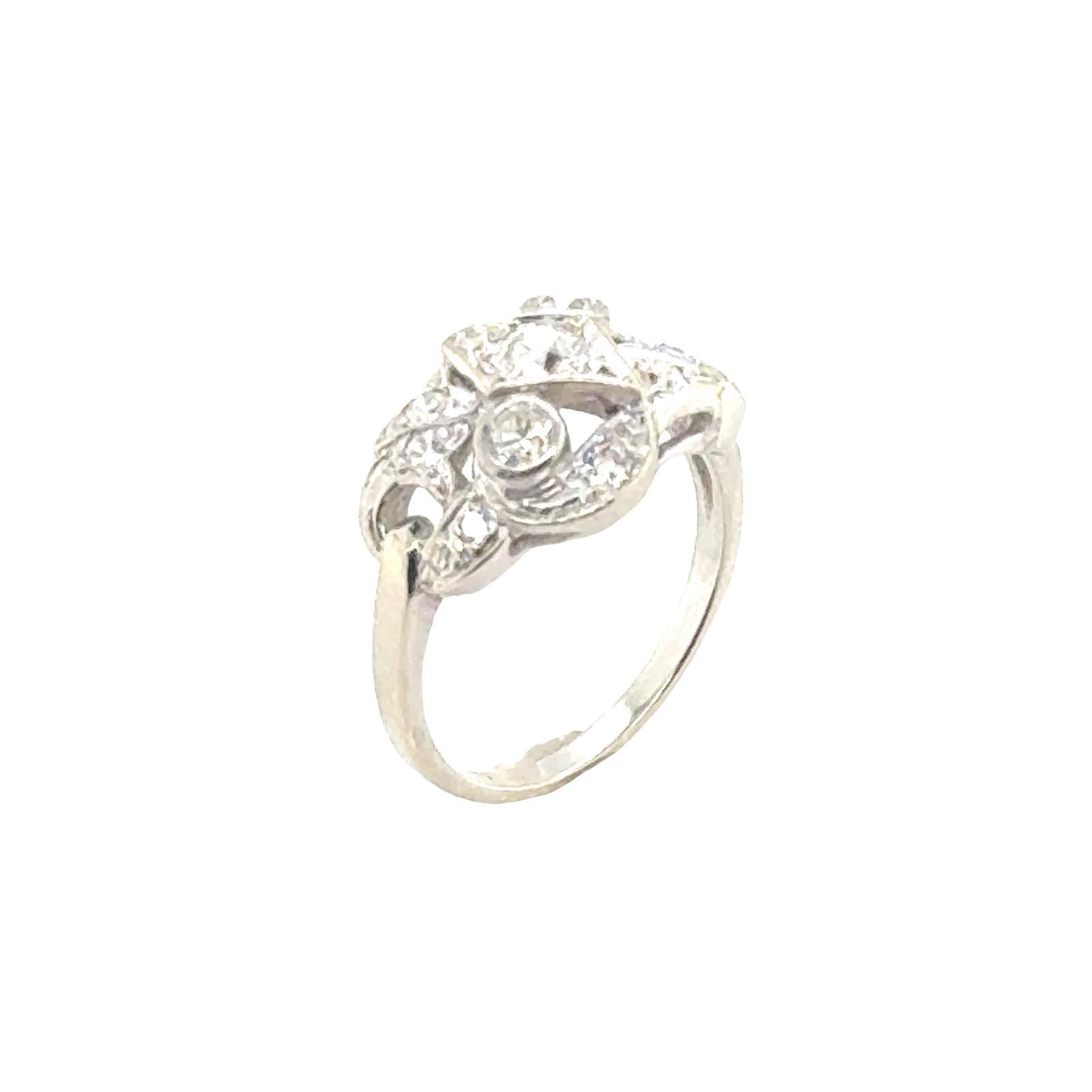 This 1940s vintage diamond cocktail ring is a captivating and elegant piece of jewelry that reflects the glamour and style of the era. The centerpiece of the ring are dazzling round brilliant diamonds, chosen for their brilliance and sparkle. The