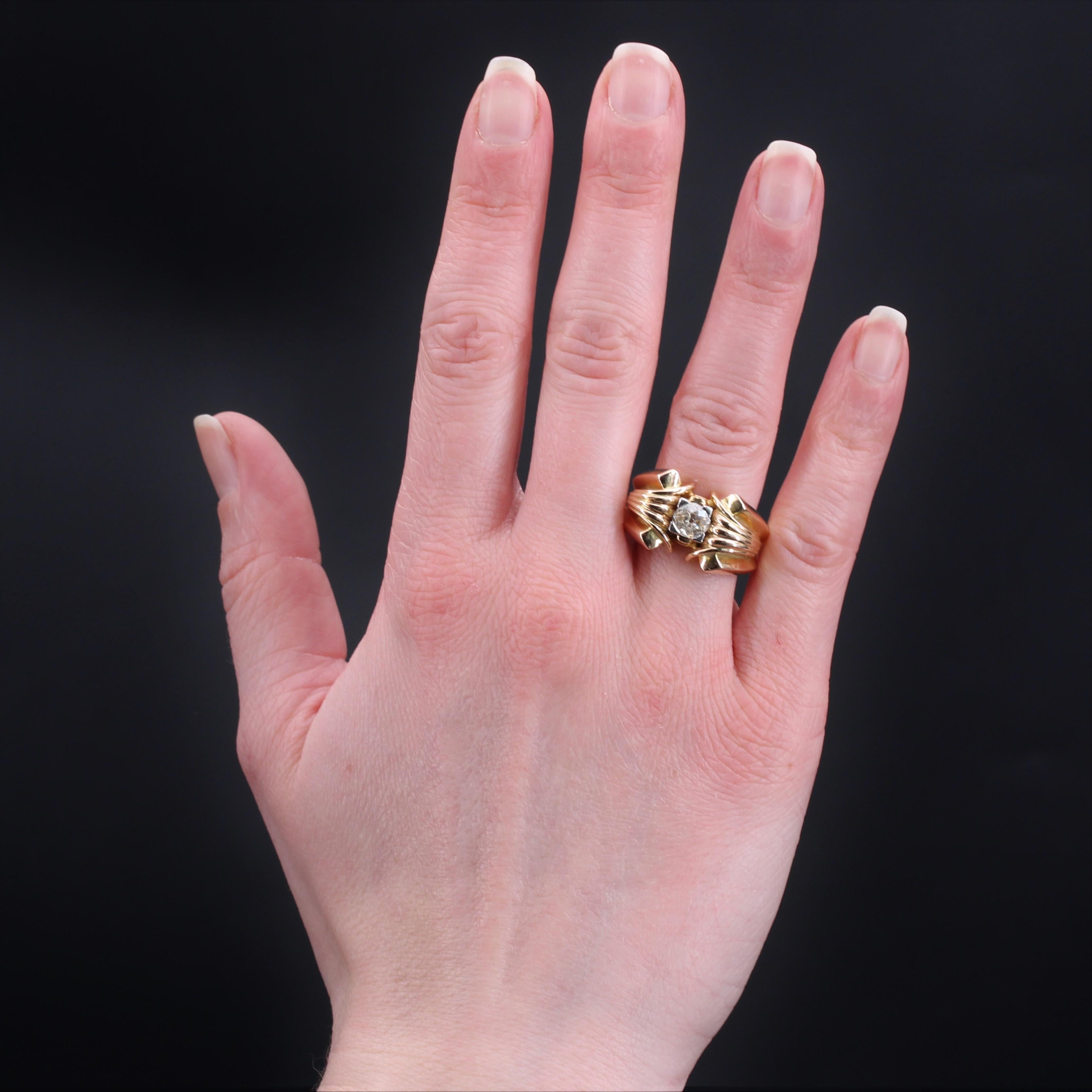 Ring in 18 karat yellow gold.
Massive tank ring, its ring is openworked on the side then decorated with a fan-shaped pattern on both sides. In the center an antique brilliant- cut diamond is set with claws of platinum.
Total weight of the diamond :