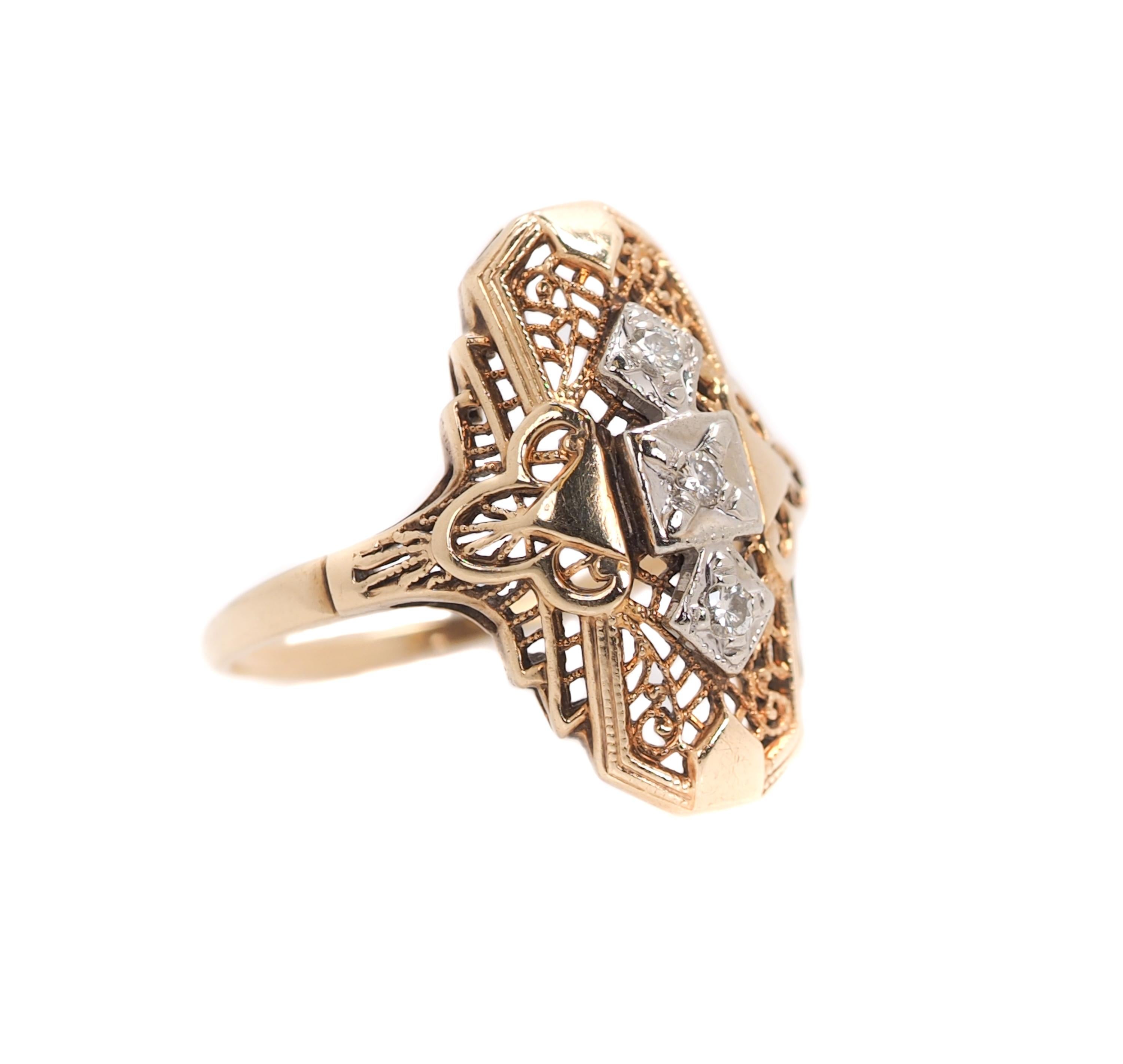 1940s Art Deco-inspired Shield Ring 

Features 14 Karat Yellow Gold Filigree with White Gold top and 3 Transitional cut Round Diamonds in prong settings.
The Diamonds are arranged vertically on the ring in white gold mountings. The center diamond is