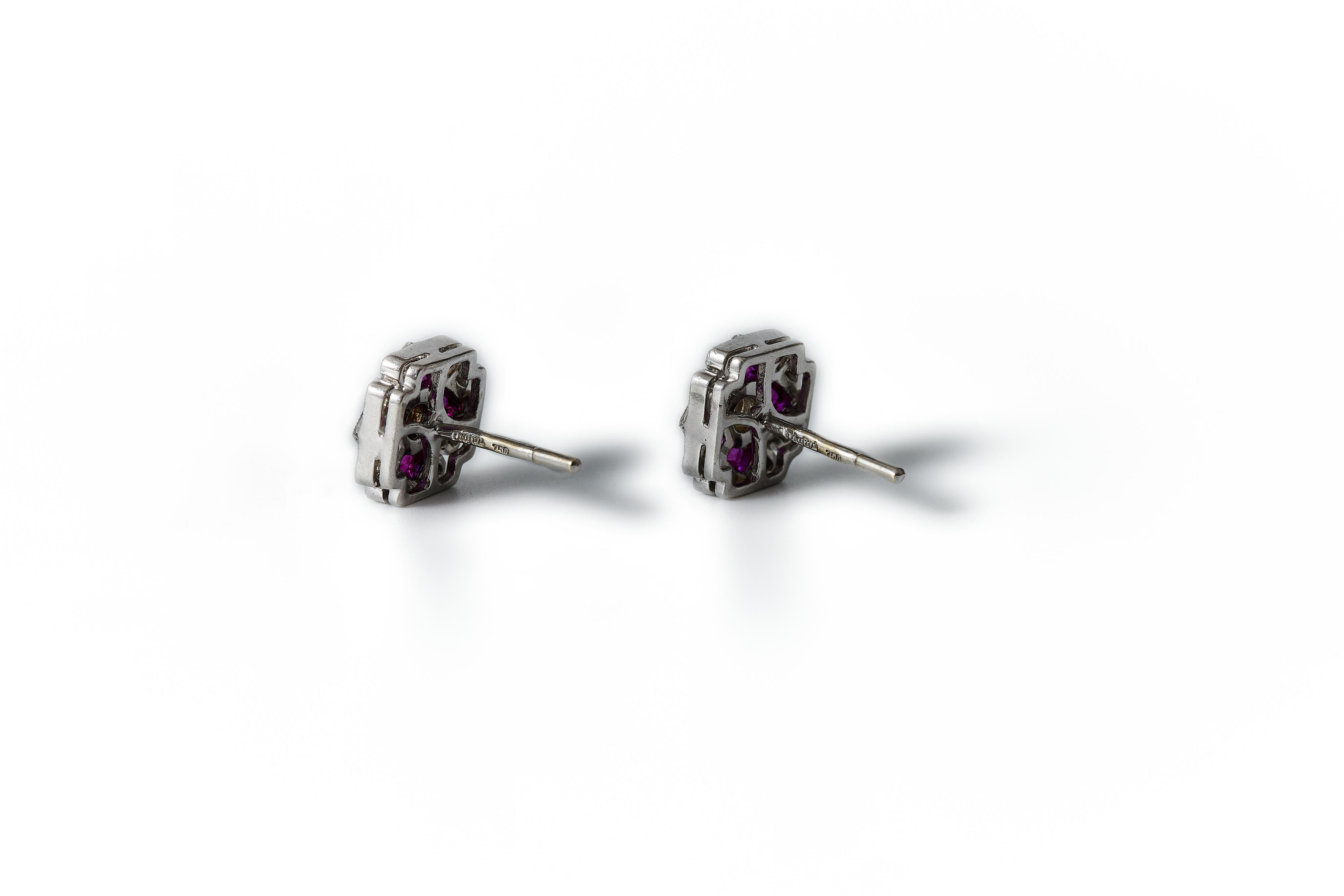 The earrings are crafted in white gold. Marked diafini and 750 on the pin. 

They measure approx. 0.39in / 1cm across. Height from ear is 0.18in / 4.5mm. The center diamond is estimated to be approx. 0.25ct, the setting makes it impossible to