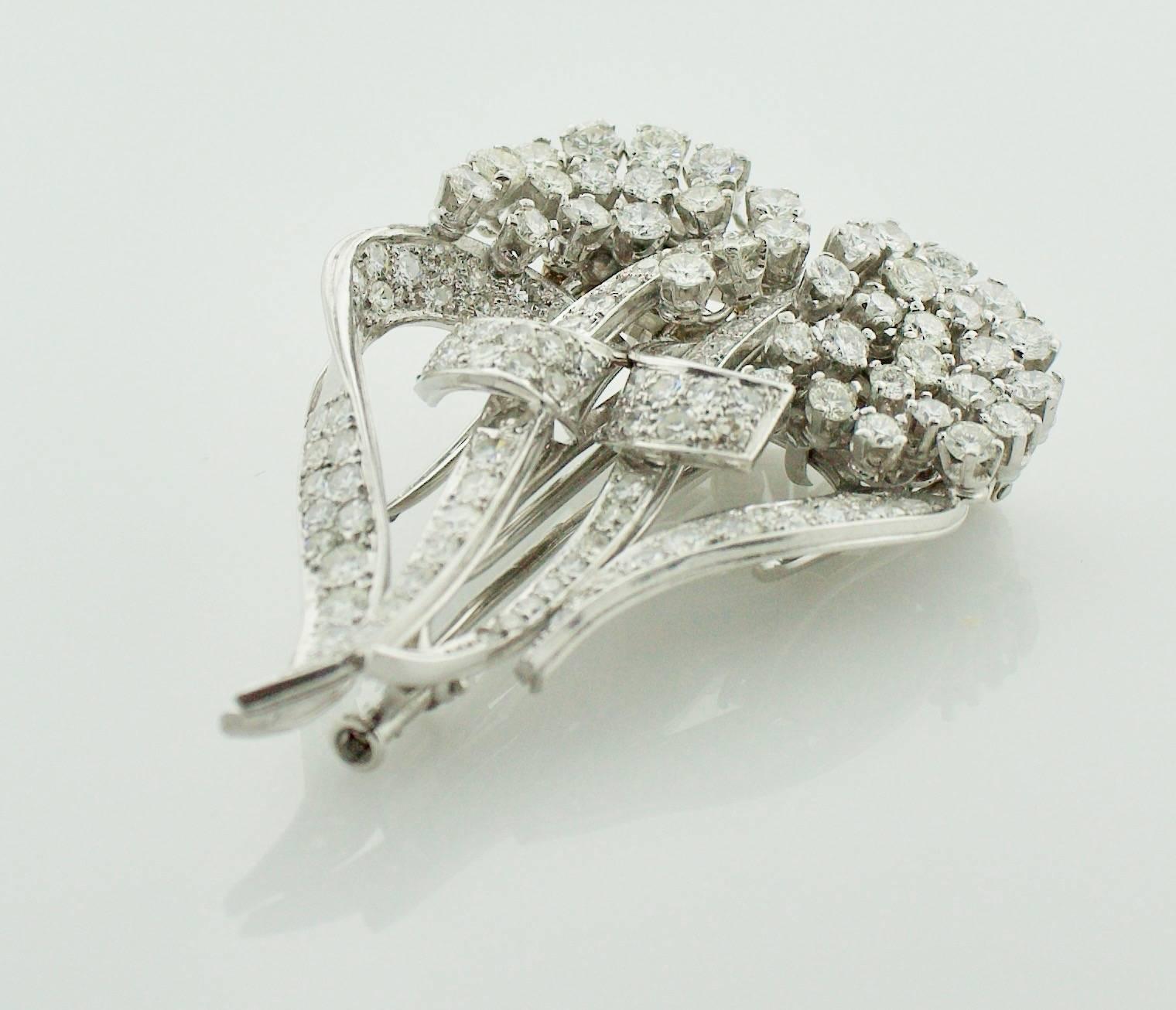1940's Diamond Brooch Clips

This stunning 1940's diamond brooch clip is a truly unique and versatile piece. It is set with 106 round diamonds, weighing approximately 6.30 carats. The diamonds are of fine quality, with a color grade of GH and a