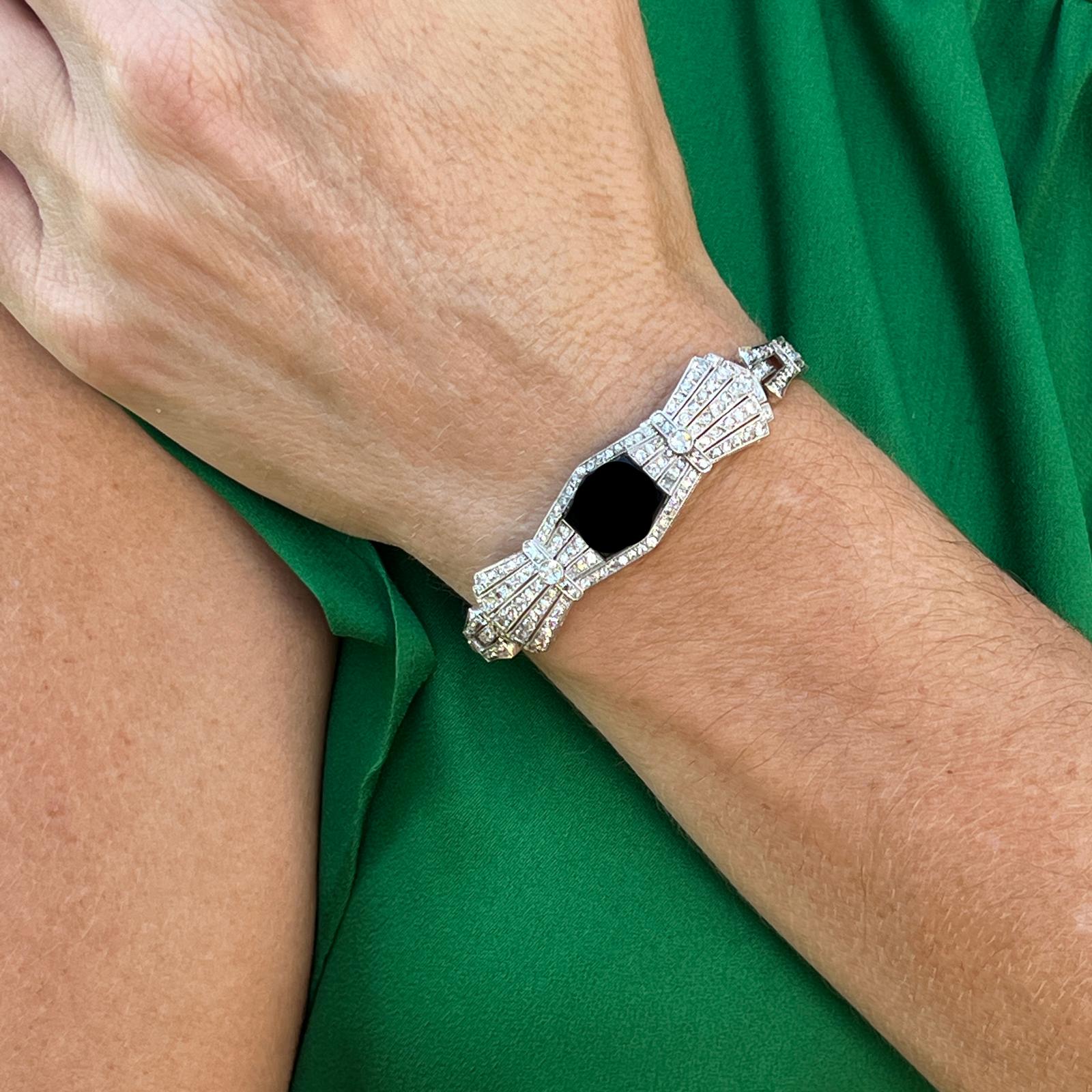 1940's diamond and onyx bracelet handcrafted in platinum. The bracelet features 136 round brilliant, old european, and single cut diamonds weighing approximately 3.00 carat total weight. The diamonds are graded H-I color and SI clarity. The bracelet