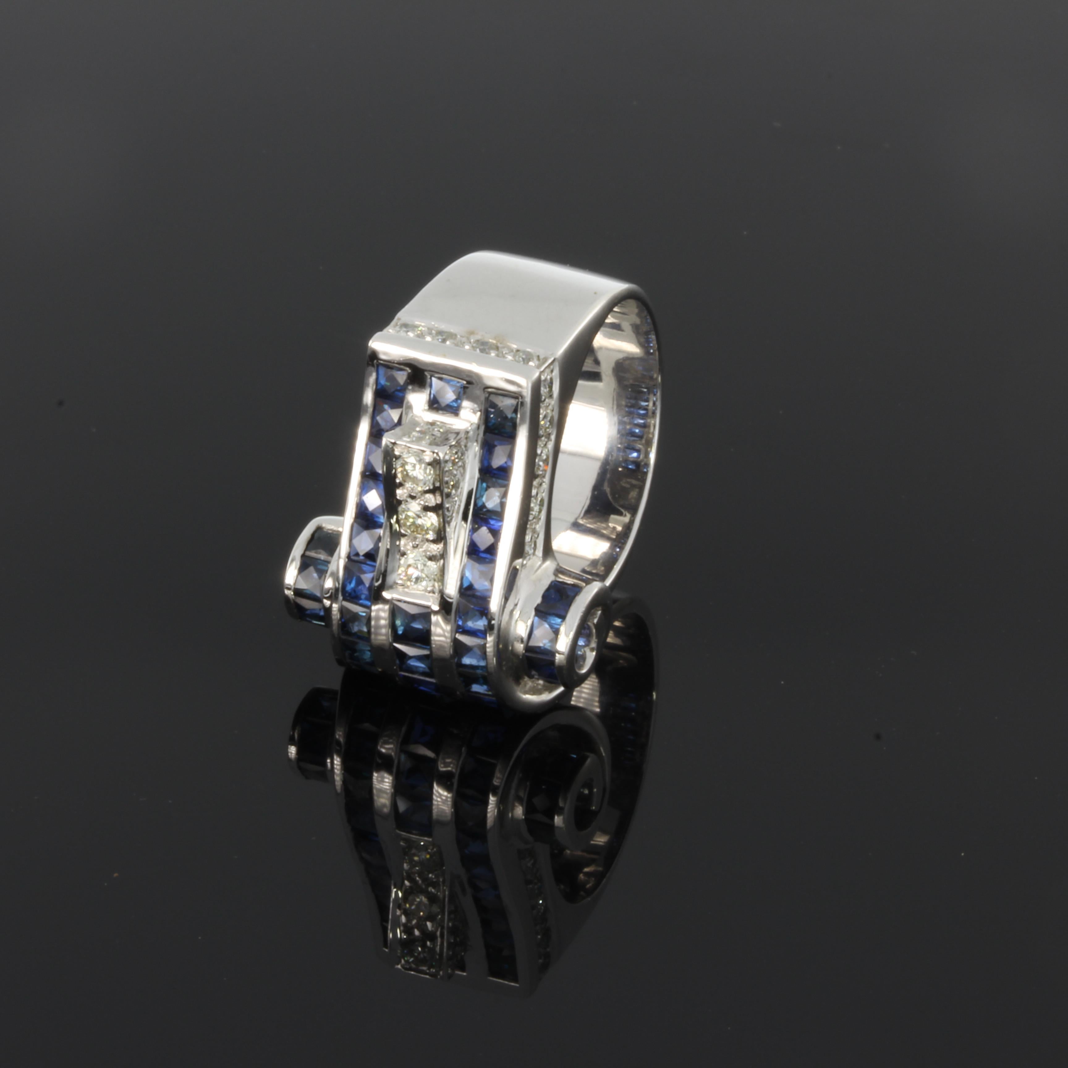 Set with 3 brilliant-cut diamonds with a total weight of 0,30 carat and 36 sapphires weighing circa 3,40 ct. 
Mounted in 18 carat white gold. Marked with the purity 18K. Weight: 18,12 grams. Ring size: 55 ( US 7 ). Resizable.


