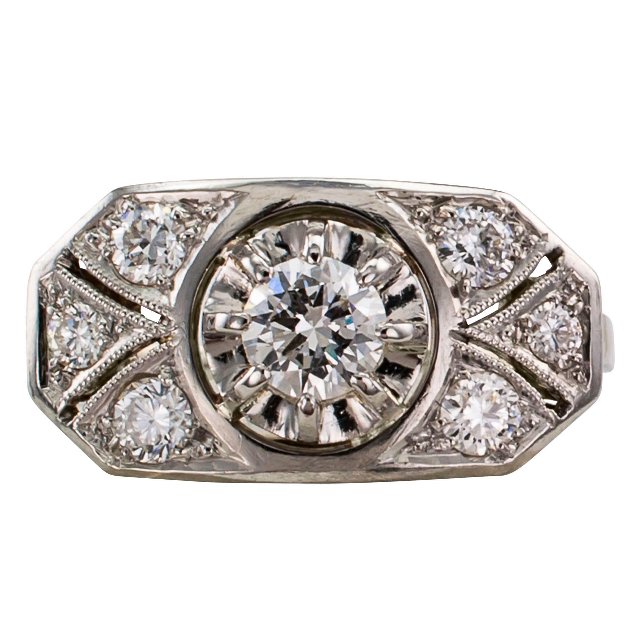 1940s diamond and white gold engagement ring.  The design centers upon  a round diamond weighing approximately 0.35 carat, approximately I color and VS clarity, prong set in an illusion head, typical of the period when it was made, within an