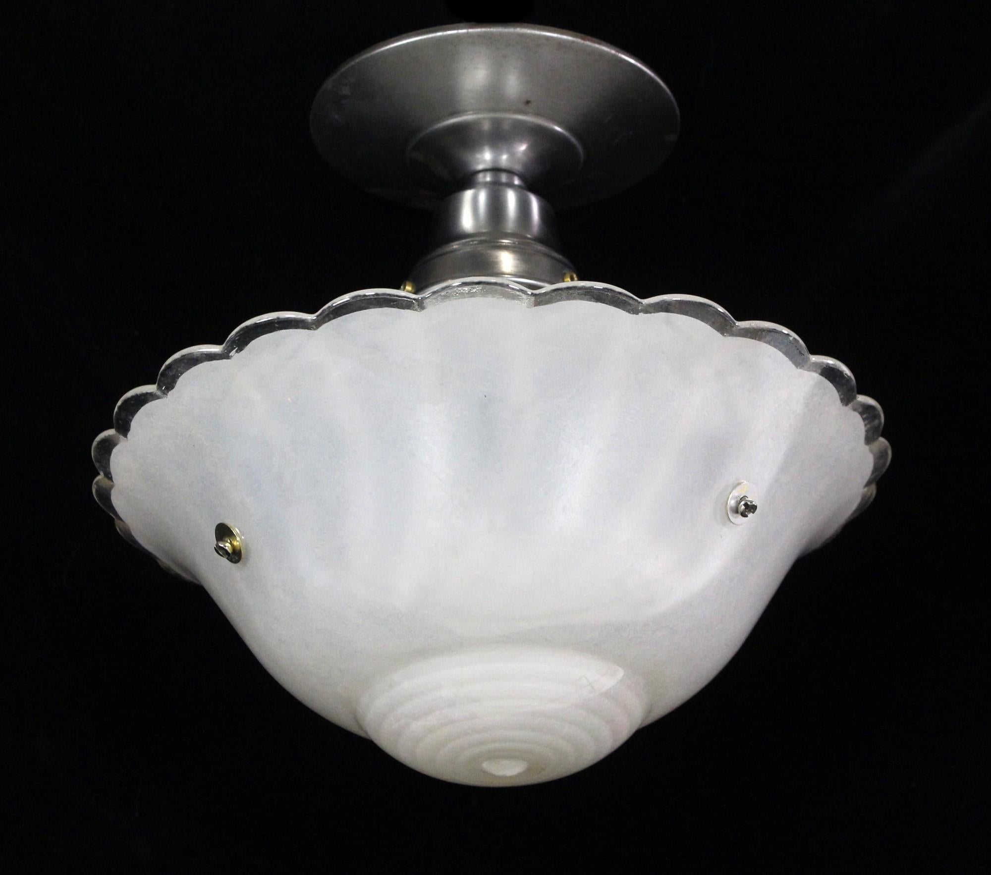 1940s white cast glass shade showing off an iridescent glow and mounted to a new nickel plated semi flush mount pendant light fixture. Takes one E26 light bulb. This can be seen at our 400 Gilligan St location in Scranton, PA.