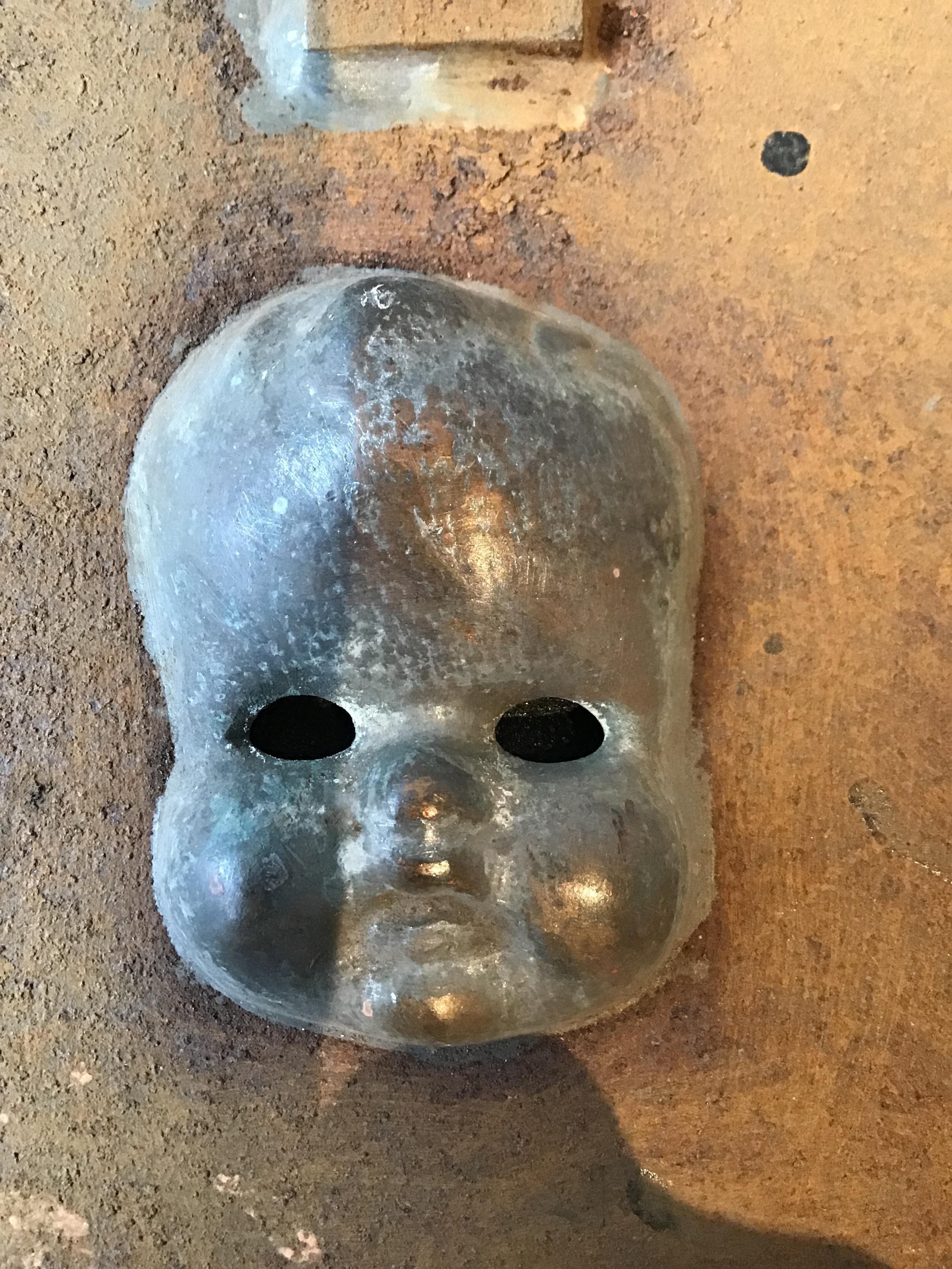 1940s Toy mold of a baby doll face.