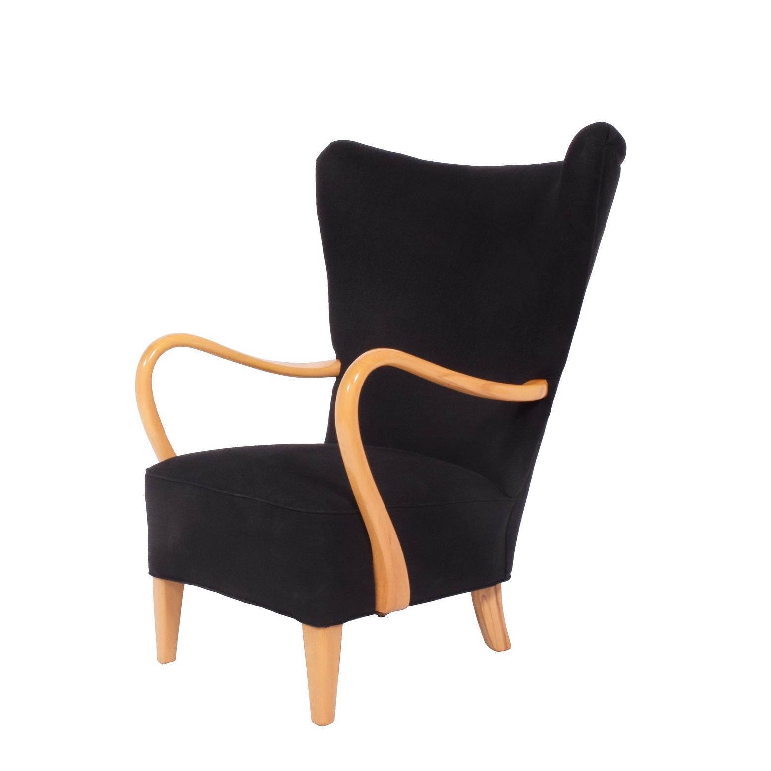 Solid birch sculptural arms and legs, free-form easy chair spring system seat new black linen upholstery. Drawing of similar example Svenska Möbler 1890-1990 page 229.