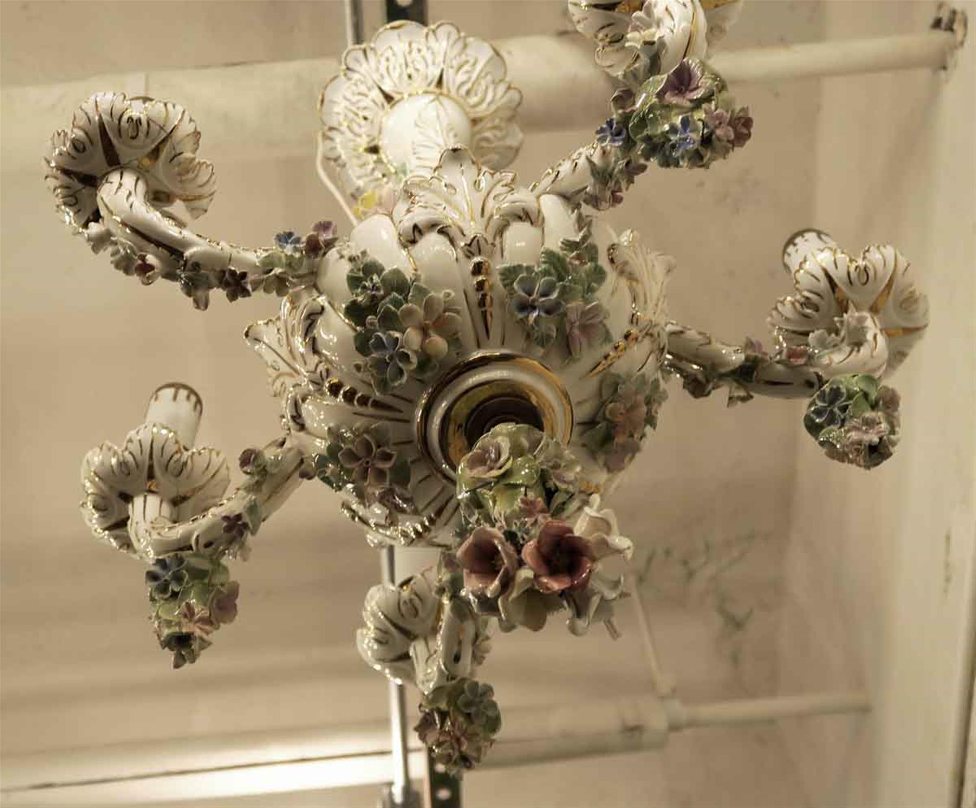 Five-arm Italian white porcelain chandelier with red and pink flowers and vibrant colors throughout. Italian 1940s One arm is missing a dangling flower accent.