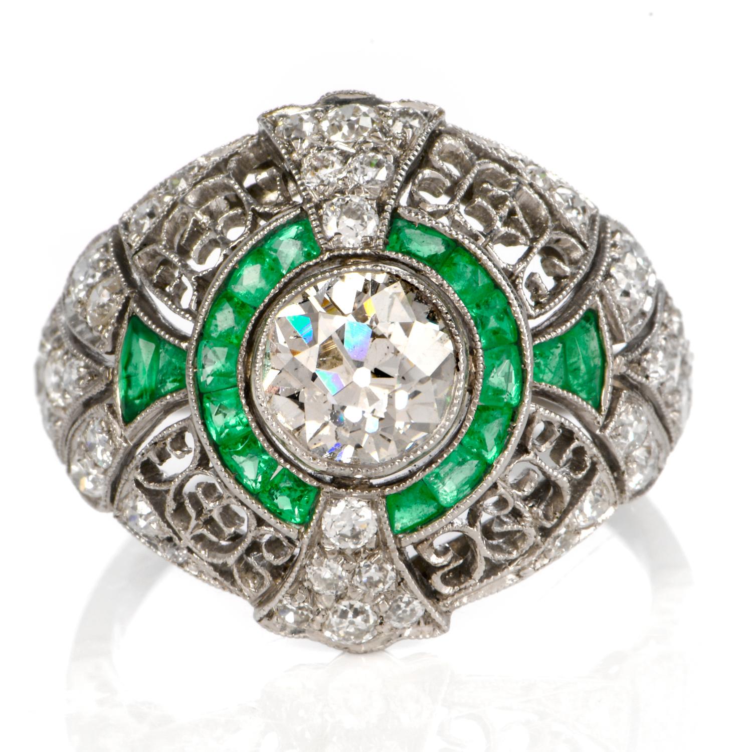 This extravagant  Edwardian Style   emerald and diamond dome engagement ring is crafted in solid platinum, weighing 6.4 grams and measuring 19mm x 8mm high. Depicting an interact open work dome design, centered with one bezel set round European-cut