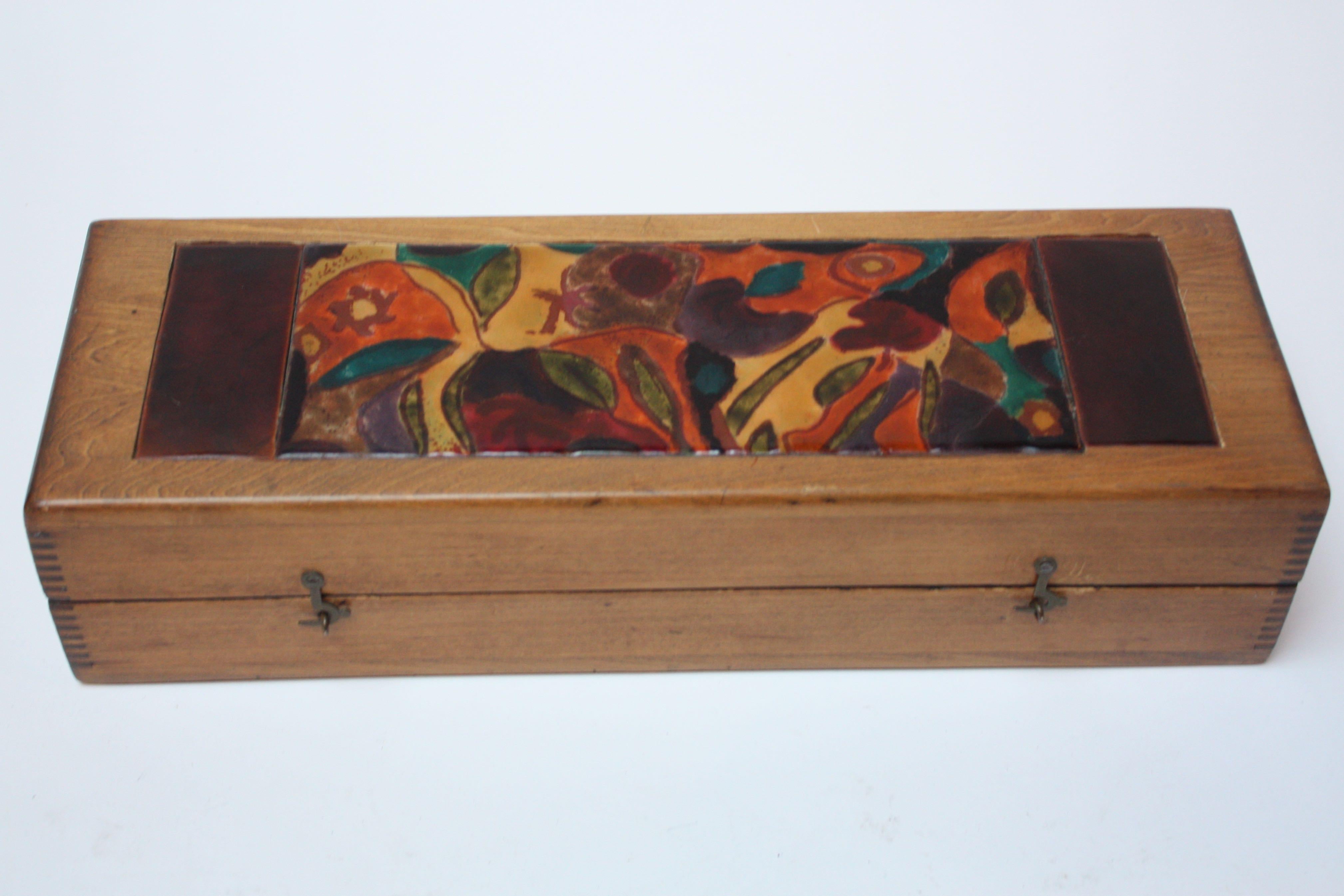 This is a nice example of artist, Elizabeth Bensley's enamel work from the late 1940s displayed beautifully on a wooden box. Note that the box top does not stay open at an angle as the hinges may suggest; it folds over and lays flat on a surface, as