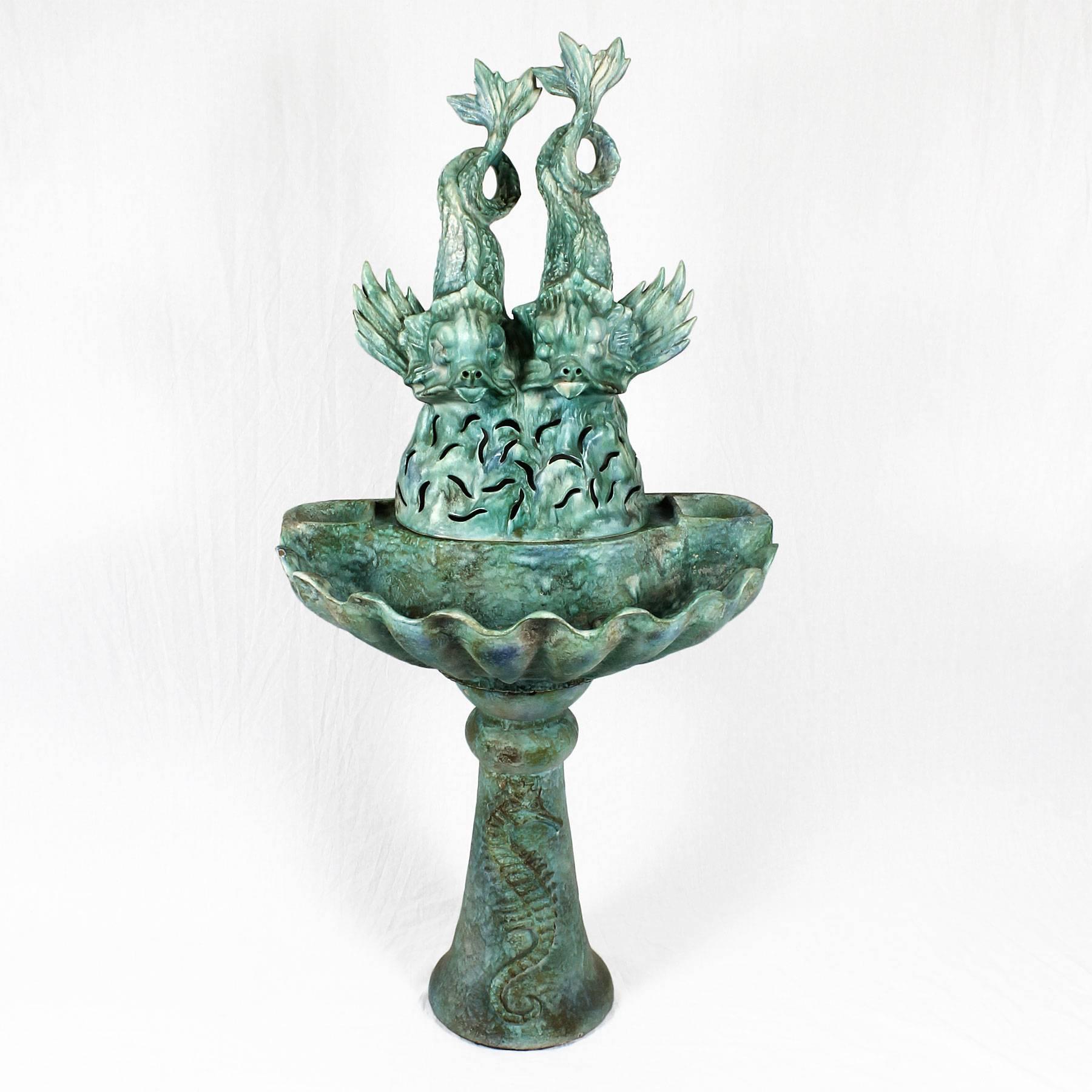 Green and blue enameled ceramic fountain, marine decoration. Form by three pieces, stand with seahorse decoration, basin (bowl) with a shell shape and a cover with dolphins decoration. Motor to be repaired.
Attributed to Clément Massier
Maker: Les