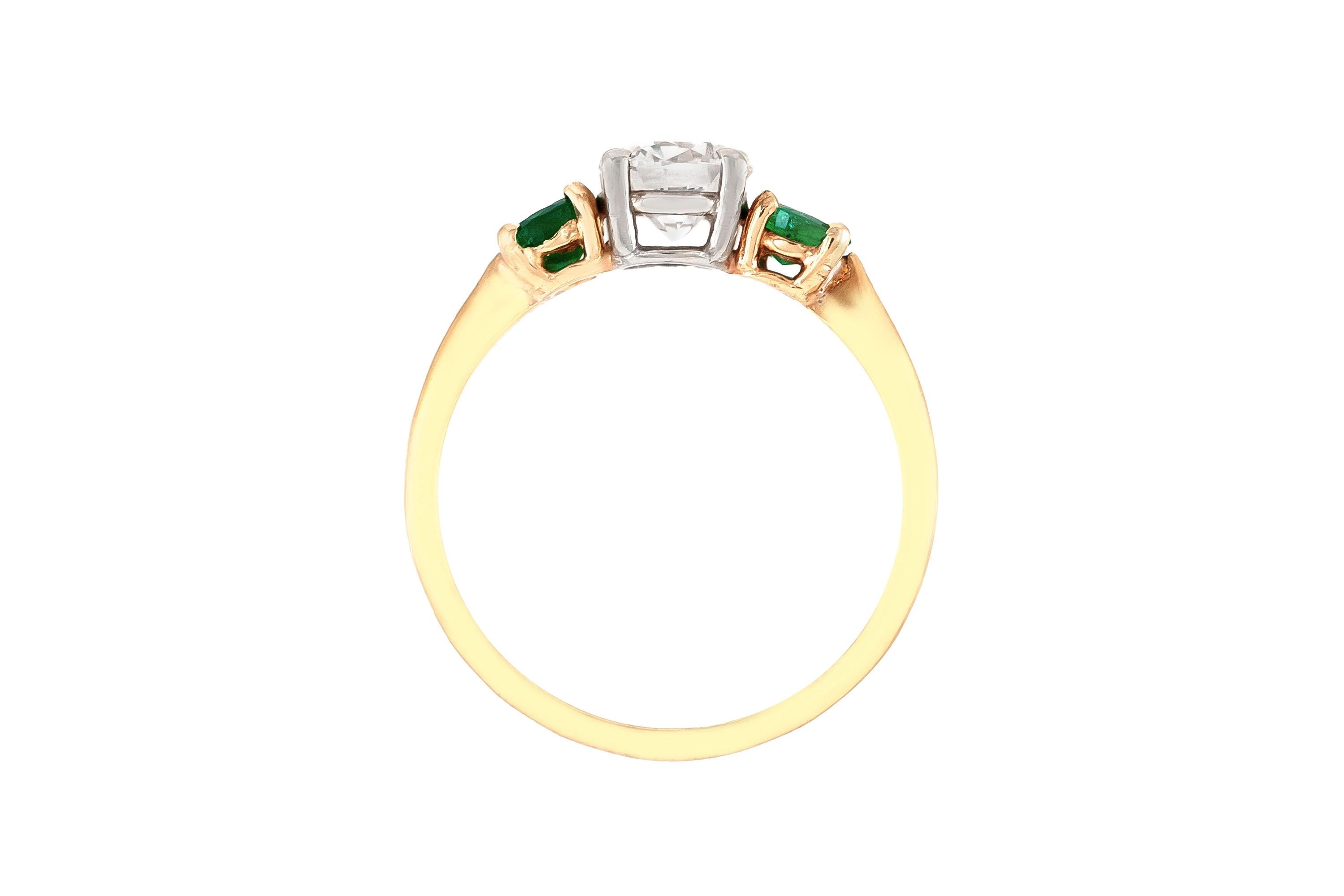 diamond ring with two emeralds
