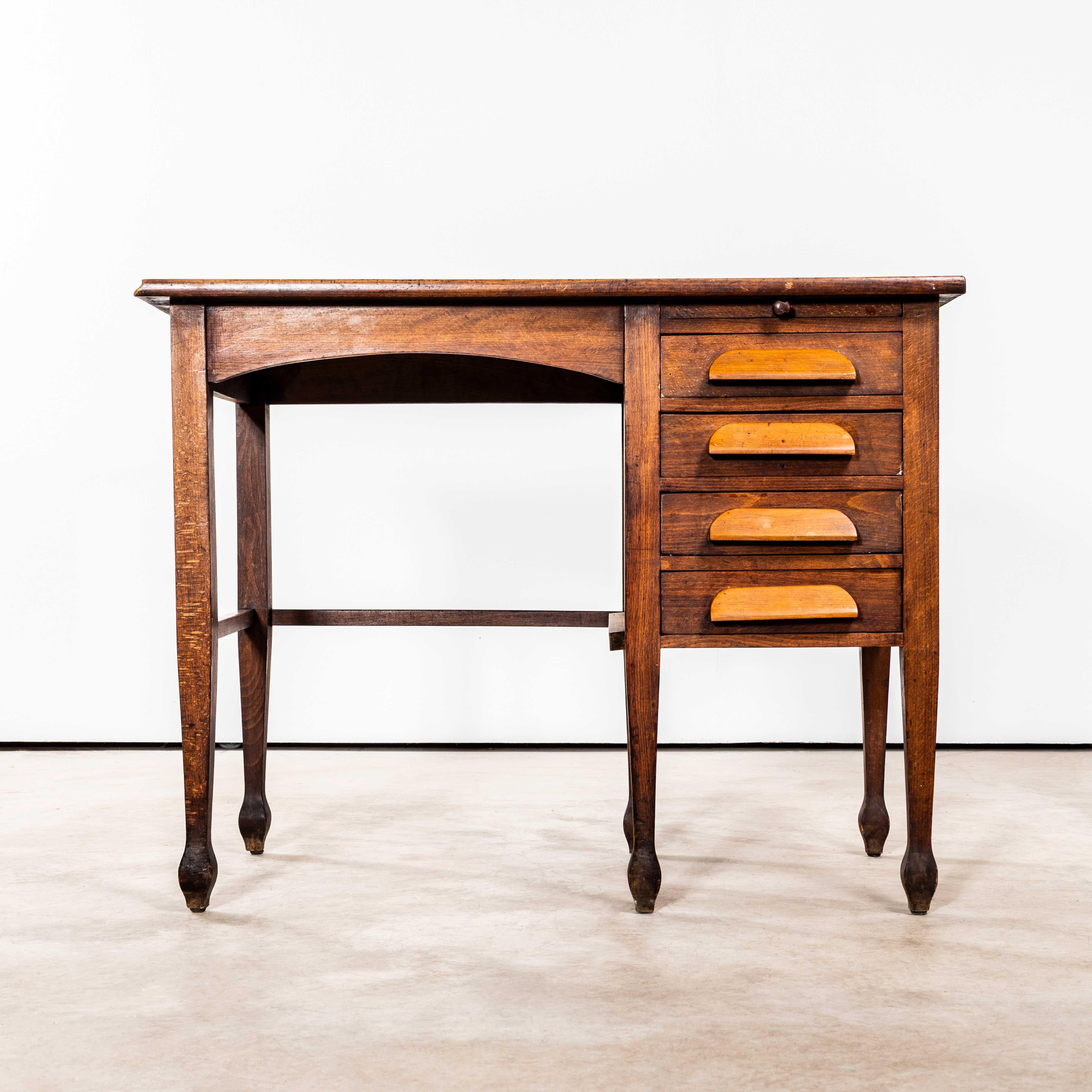 1940’s English Oak Compact Desk – Four Drawer. 
Practical petite desk in superb original condition. Made mainly in oak with ash handles. The desk has four drawers and a little slide ledge.
Drawer Internal Dimensions: L35 x W22 x H5 cm.
Knee
