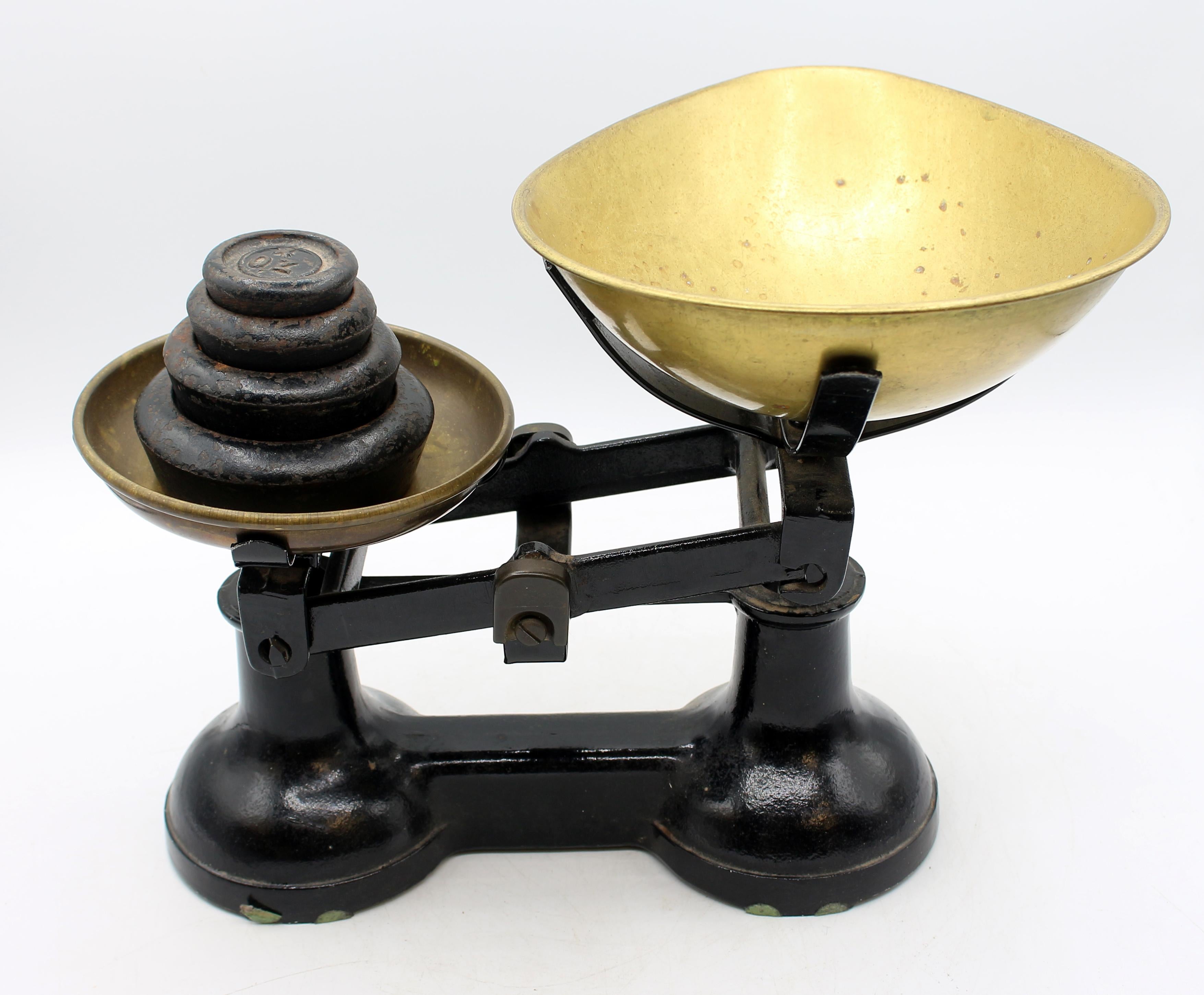 1940s The Viking scale & weights by F.J. Thornton & Co Ltd, Wolverhampton, UK. Cast iron black painted with gilt manufacturer's information & emblem. Brass weight & dry goods holders. Four black painted cast iron circular stacking weights. Wear to