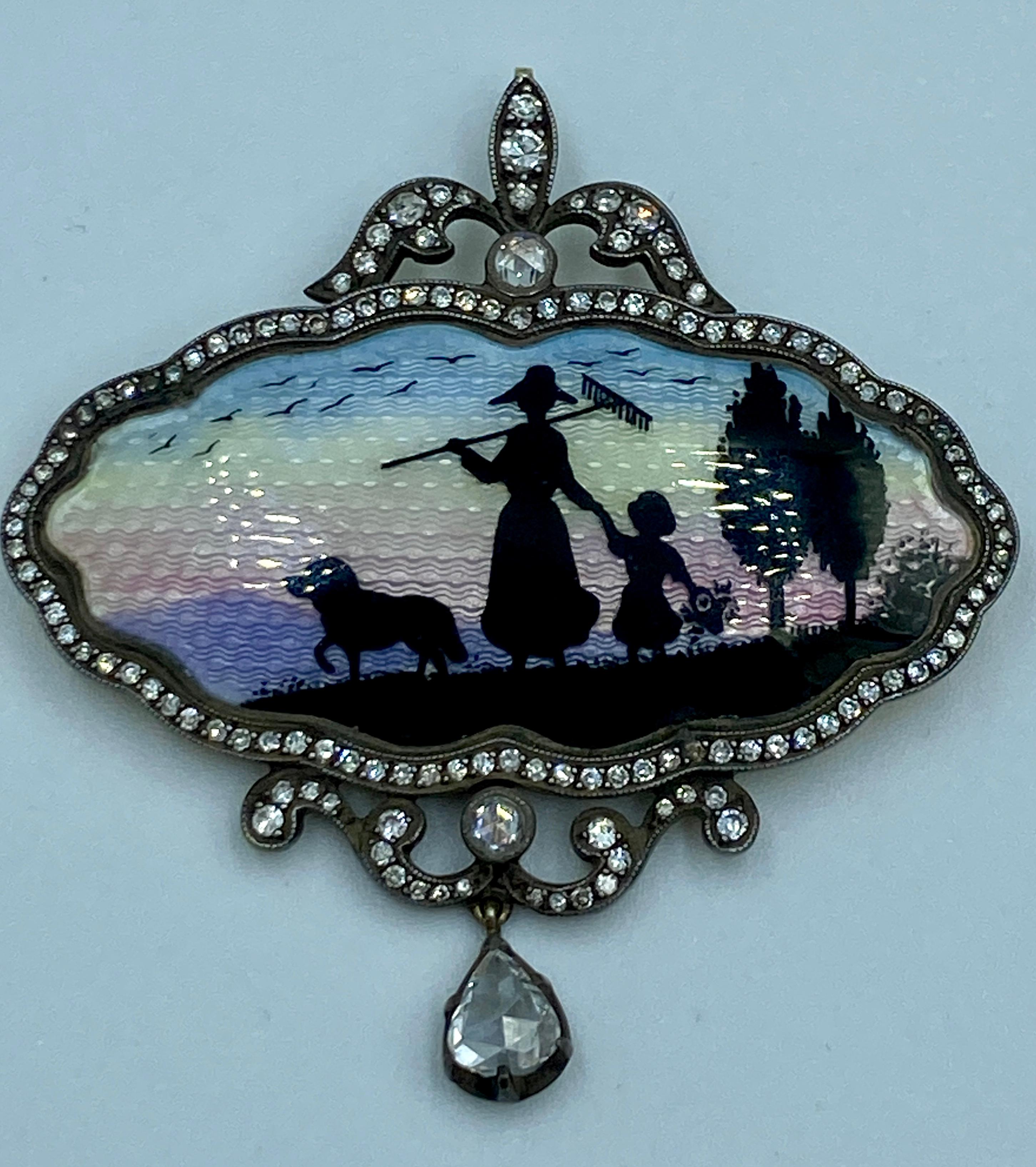 This 1940s pendant/brooch is made of 18k gold. The vignette on the front is that of a shepherdess holding a young girl by the hand and accompanied by a sheep dog and is made of enamel. It is framed with a row of round cut diamonds set in silver. The