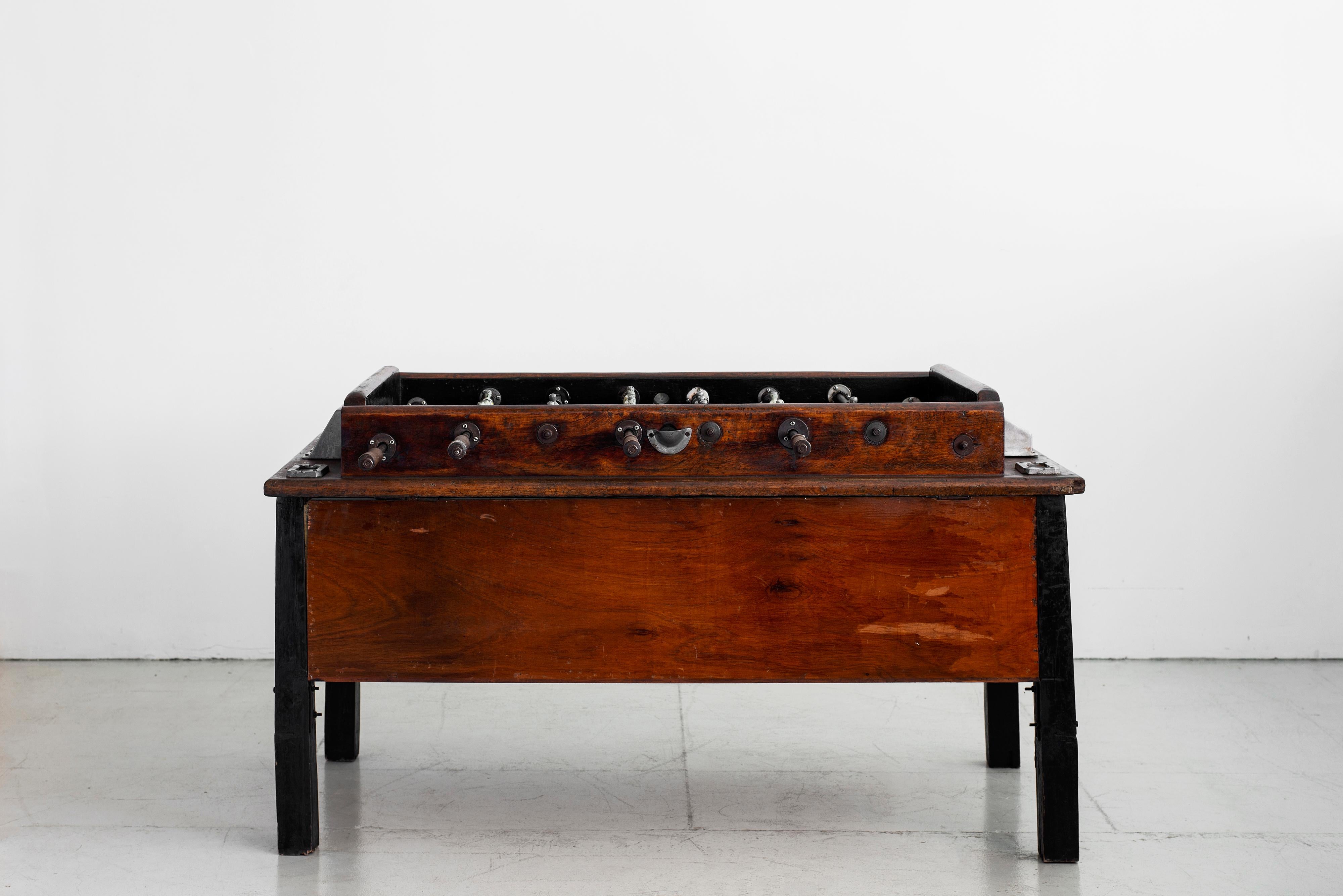 Great European 1940s foosball with original aluminum players and original balls. Hand painted playing field with fantastic patina throughout. 
  