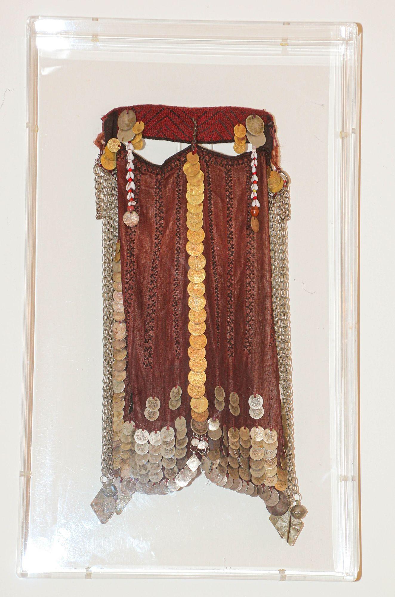 Traditional antique circa 1940s Clectible women face veil from the Sinai Bedouin Desert Garment Nikab framed in a lucite box. Museum quality well preserved Middle Eastern Bedouin women face veil, from the Bedouin tribes of the Sinai Desert.
*