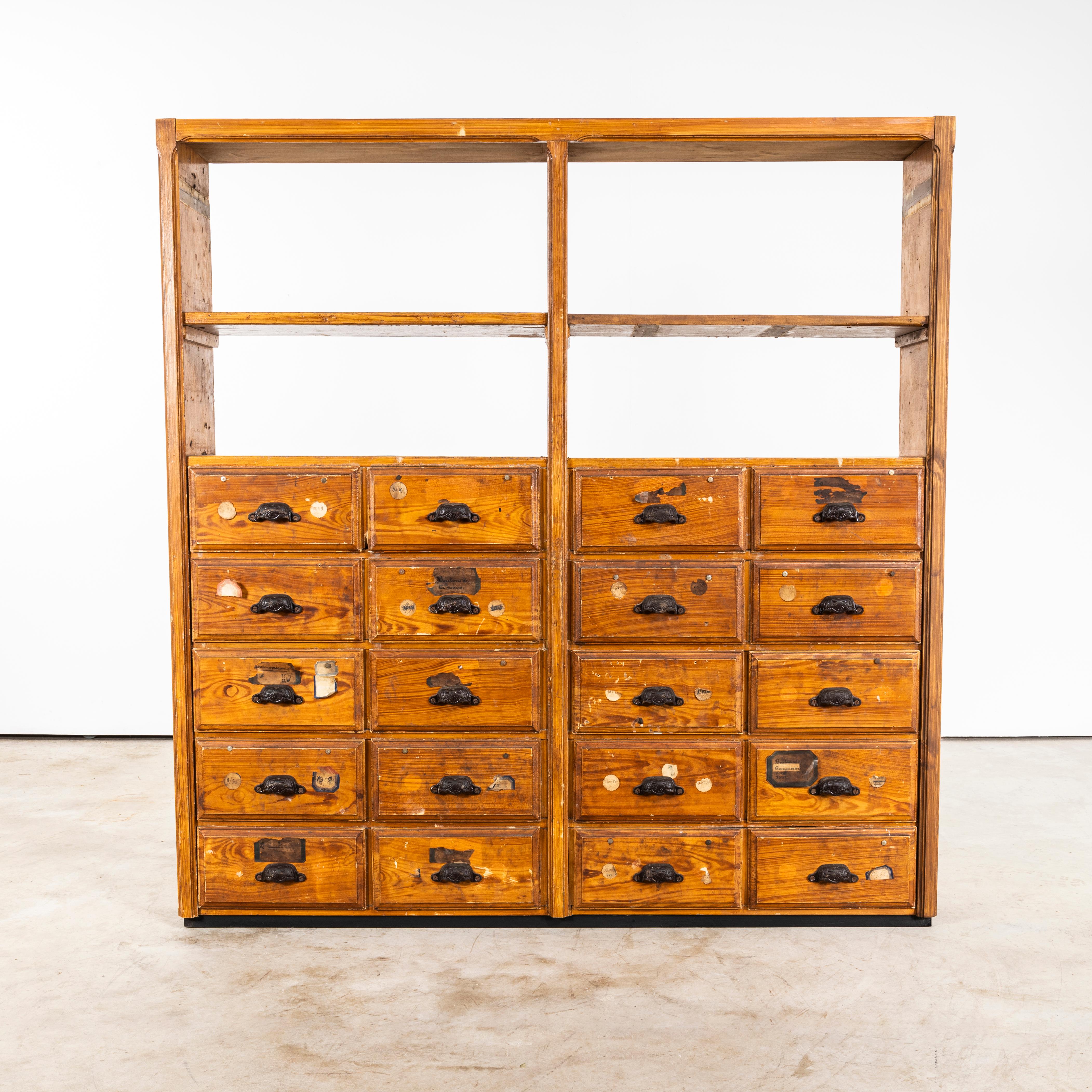 1940's Faux Wood Workshop Shelving - Twenty Drawers. 

Very early original French hardware shelving unit. Made in solid pitch pine it retains most of the original faux oak woodgrain finish and all of the early original heavy pressed steel handles.