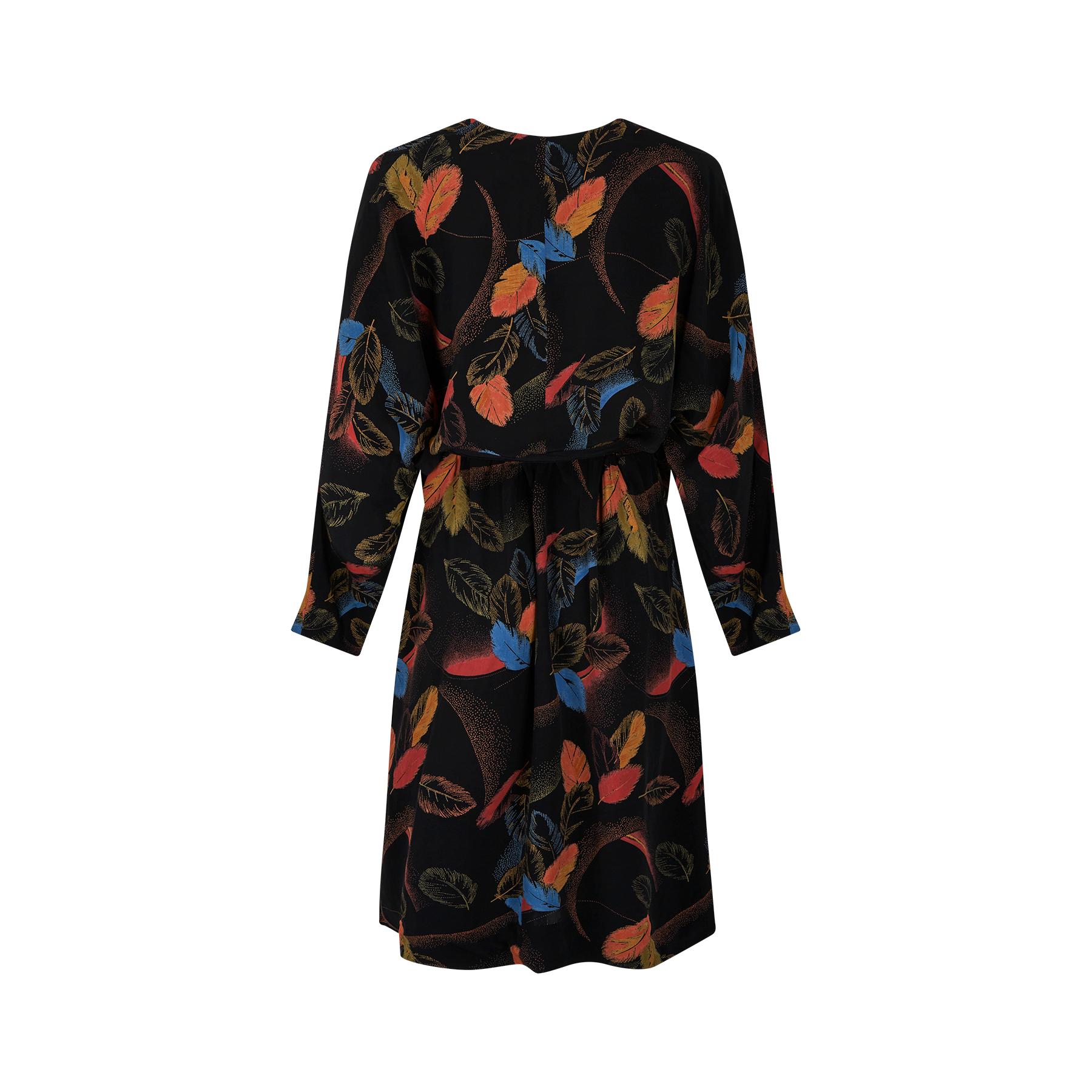 Original cold rayon novelty feather print wrap dress dating to the 1940s. It is in really vibrant colours of orange, yellow and blue against a black background and is a combination of bold block colour feathers and a pixilated more abstract design. 