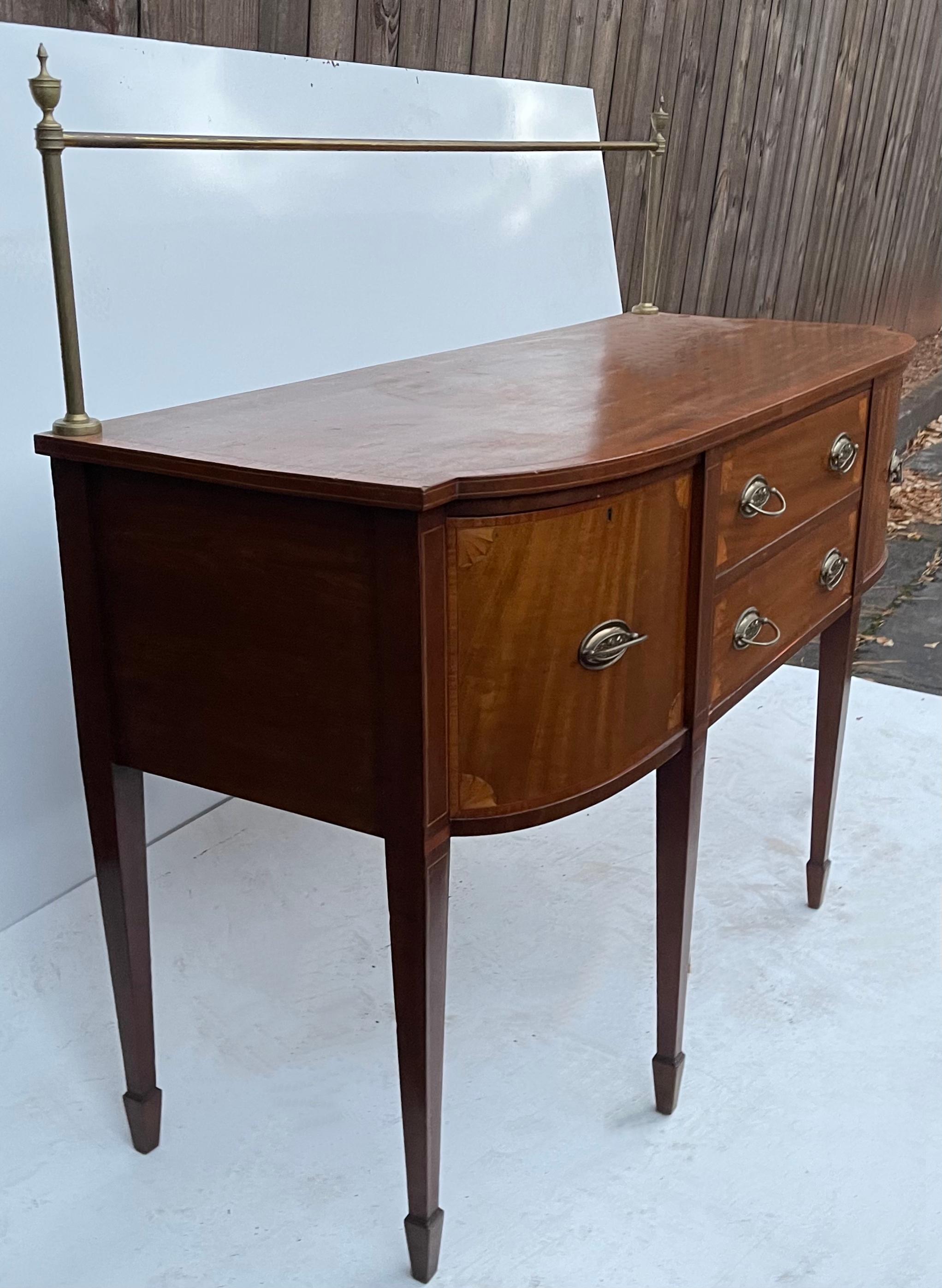 This is a special piece! I love the size and inlaid details in the corners. This is a 1940s Federal style sideboard with brass gallery. The height from the floor to the serving surface is 36.5”. It is in wonderful condition and is unmarked.