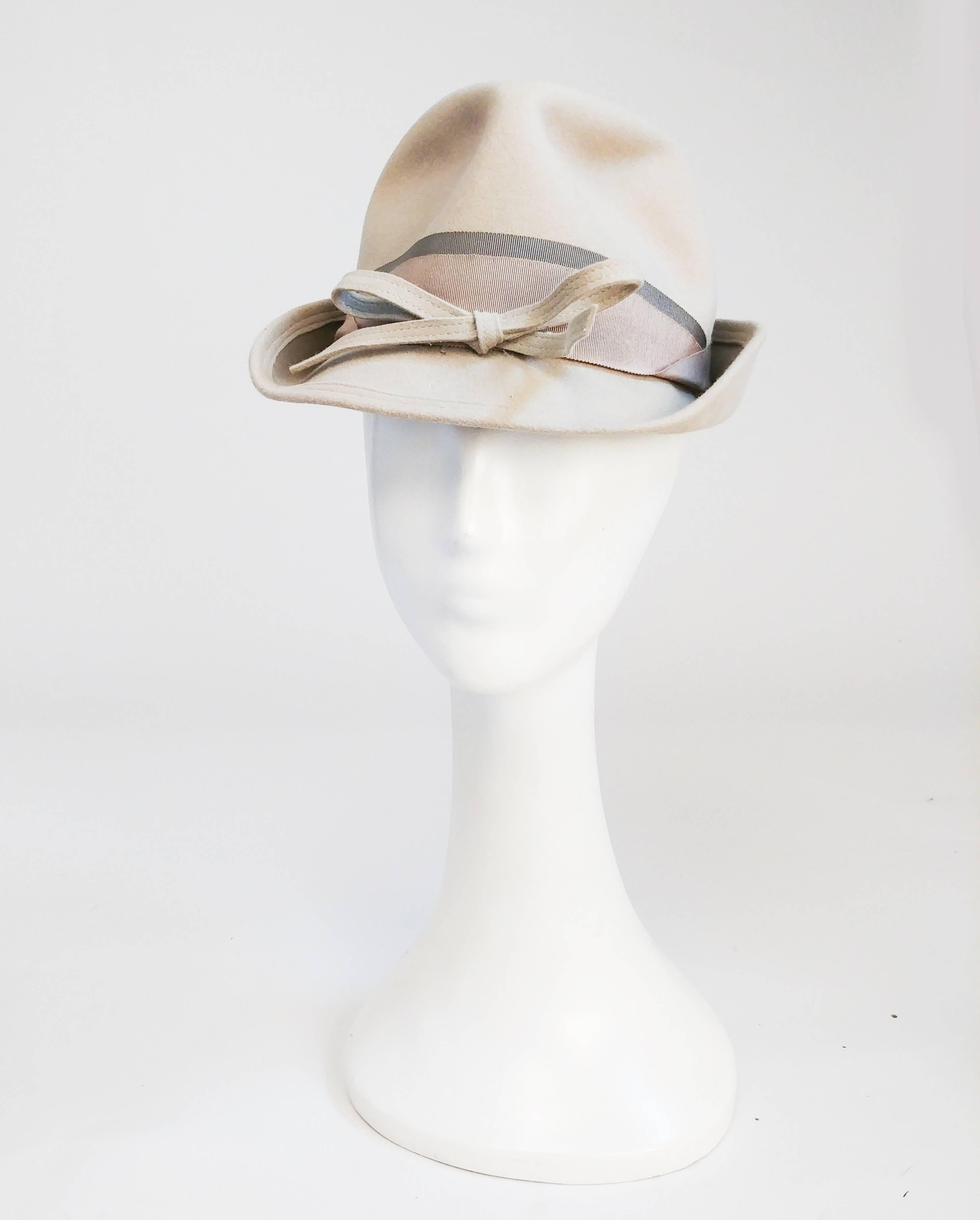 1940s Feminine Fedora w/ Bow. Taupe feminine felt fedora with multiple bands and a felt bow. 21 inch circumference.