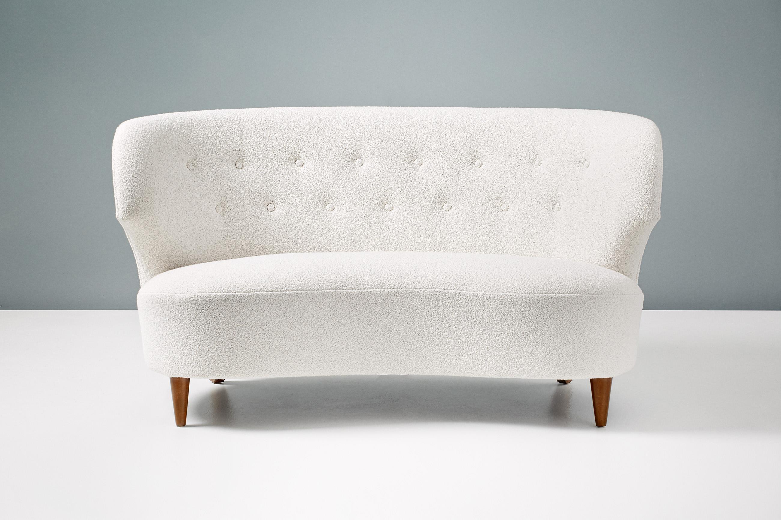 Carl-Johan Boman

Curved love seat sofa, circa 1940

This 2-person sofa was produced in Finland by Oy Boman AB in the 1940s. It has been refurbished and reupholstered at our London workshops and finished in off-white cotton-wool blend boucle