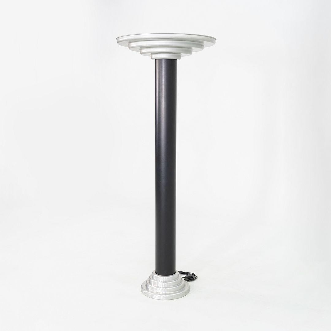This is an Art Deco period torchiere floor lamp in the Streamline style, manufactured in the 1940s by Firma Keiser in Germany. The design features an enameled metal base in black, with an aluminum top and base. The wiring is original to the piece
