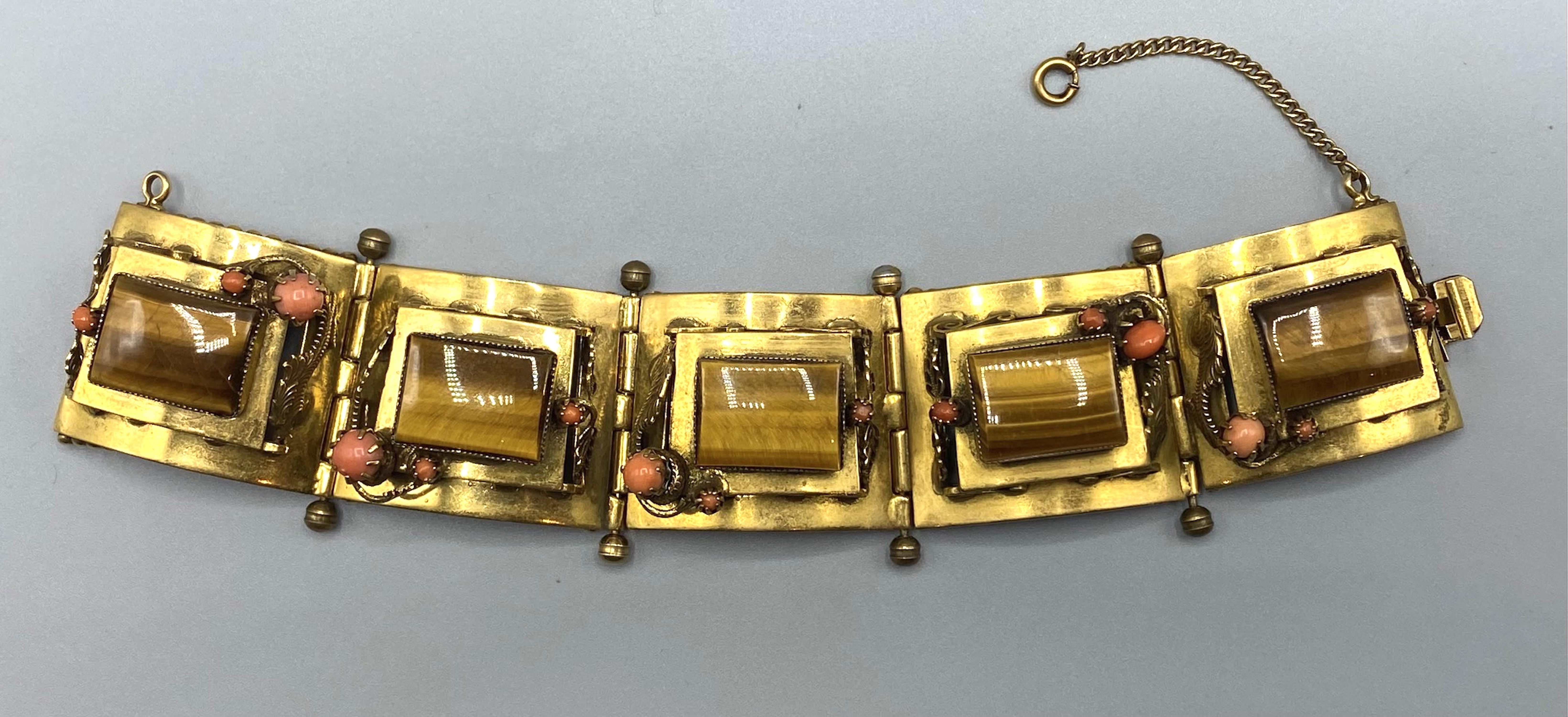 An Unique and wonderful 1940s/50s handcrafted gold plated bracelet, composed of 5 heavy panels decorated with real coral and tiger's eye.
Very elaborate and exquisitely made.