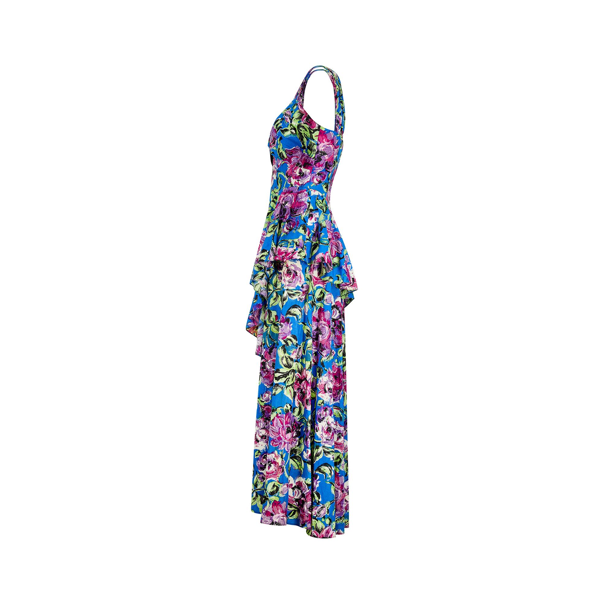 A floral maxi dress, done with that distinct 1940s elegance and would work well for both day and evening event wear. The lightweight cloth is an early textured viscose with a subtle speckled finish when looked at up close. It is patterned with bold,