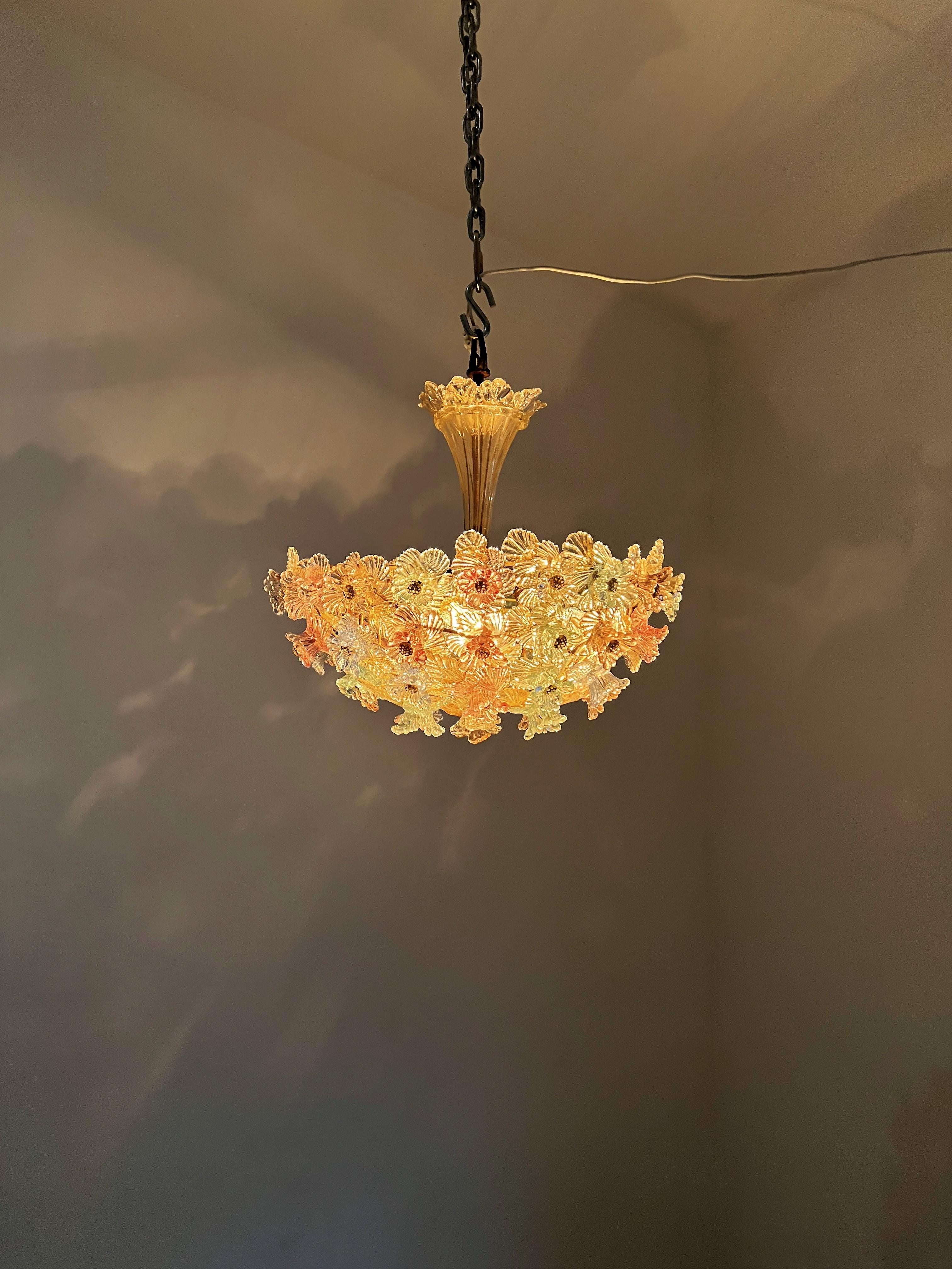 Beautiful chandelier, manufactured in Murano Italy circa 1940 and attributed to the Barovier & Toso factory.
Each flower is hand made in a 3 Dimensional design and done in different shade of pastel toned Murano glass. the central flute's glass is