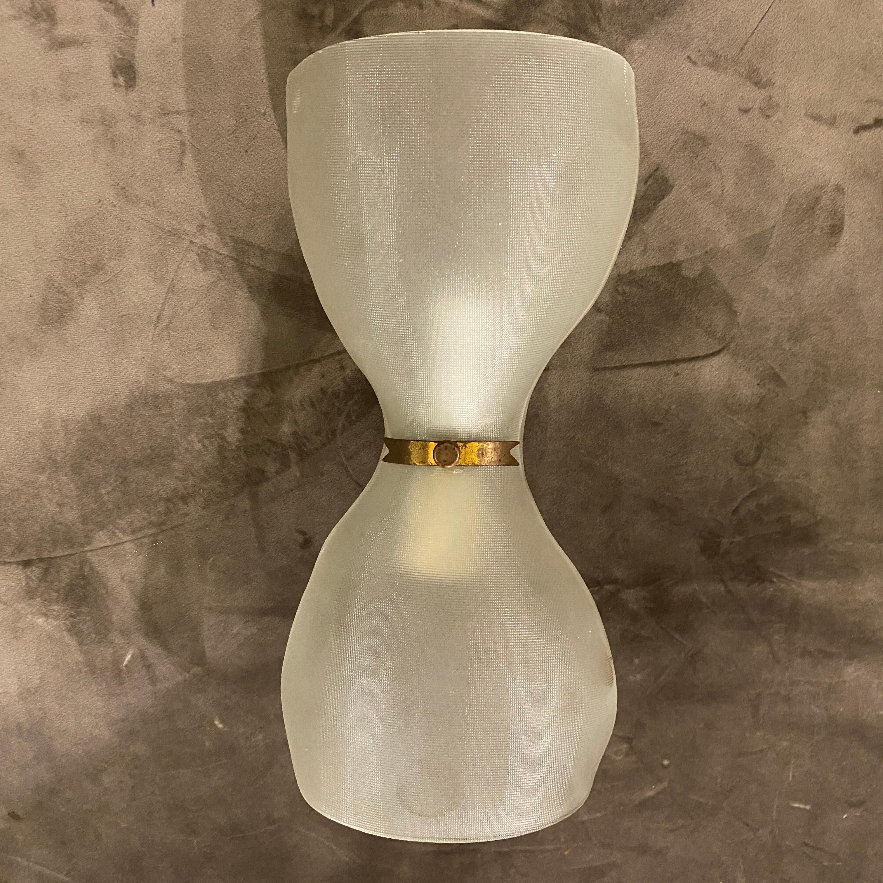 A single wall sconce made in Italy by Fontana Arte, the particular glass it's hand-crafted, brass it's in original patina. It works 110-240 volts and needs regular e14 bulbs.