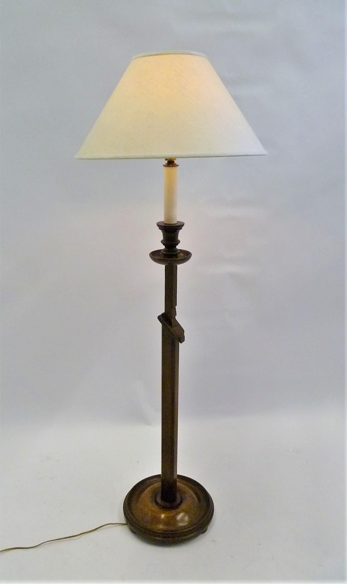 A great 1940s ratcheting mahogany floor lamp with carved, ratchet notches to adjust the height, and a beautiful turned wood base and lathe turned wood bobeche and faux painted wood candle at the socket. It is attributed to Francis Elkins (b.