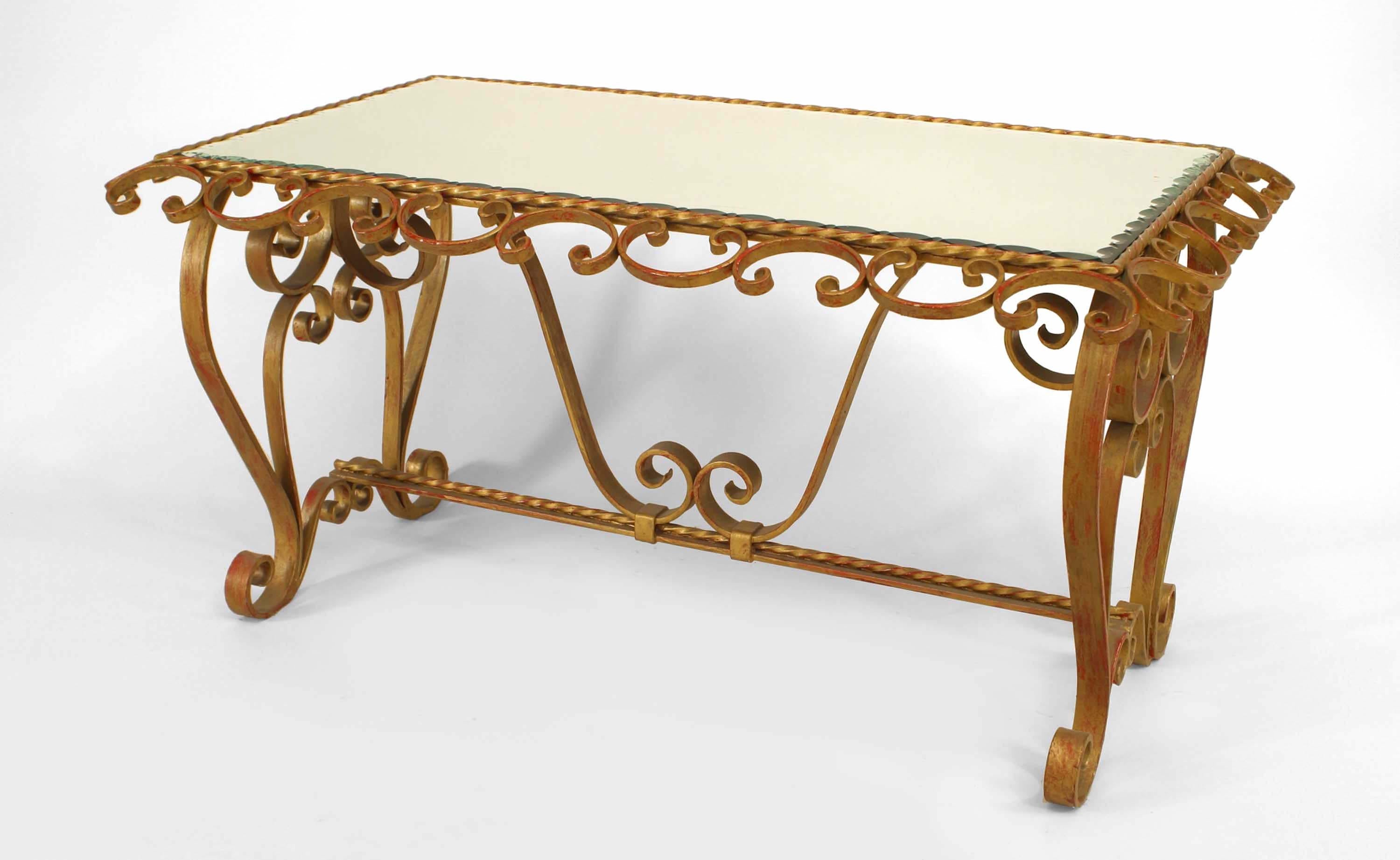 French Art Moderne (1940s) gold painted wrought iron coffee table with scroll / twisted iron details and beveled trimmed edge mirror top.

